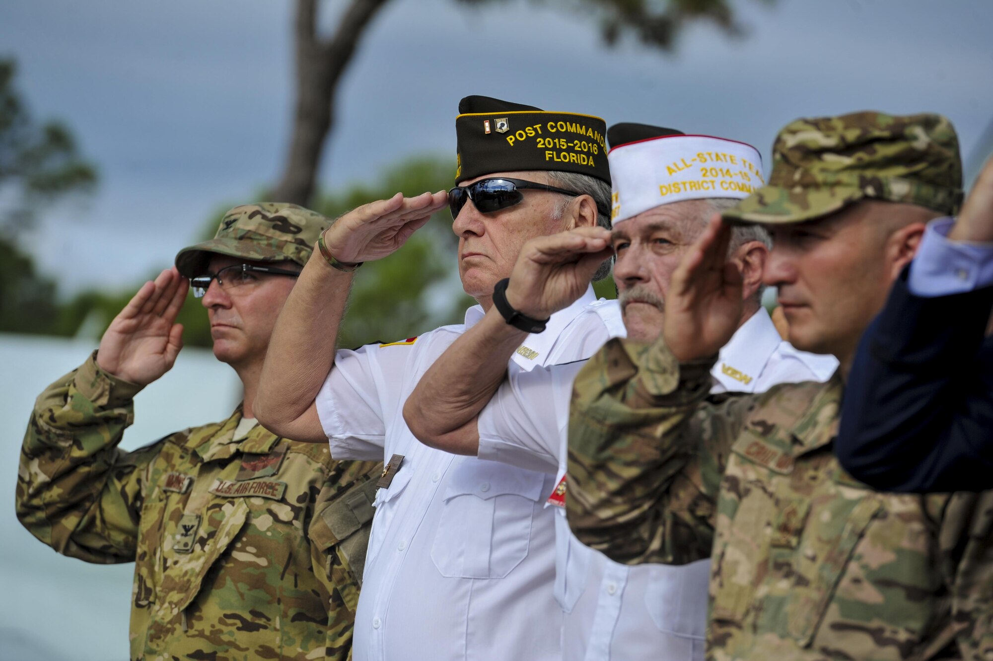 Service members, past and present, salute while the national anthem plays during a POW-MIA ceremony on Hurlburt Field, Fla., Sept. 16, 2016. A 24-hour ruck-march vigil was held in remembrance of prisoners of war and those identified as missing in action that culminated in a ceremony at the Hurlburt Field Air Park. (U.S. Air Force photo by Airman Dennis Spain)
