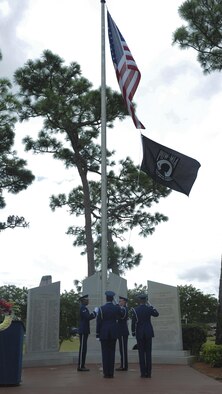 Members of the Hurlburt Field Honor Guard raise the POW-MIA flag during a ceremony at Hurlburt Field, Fla., Sept. 16, 2016. A POW-MIA ceremony marked the end of a 24-hour ruck-march vigil in remembrance of prisoners of war and those identified as missing in action. (U.S. Air Force photo by Airman Dennis Spain)
