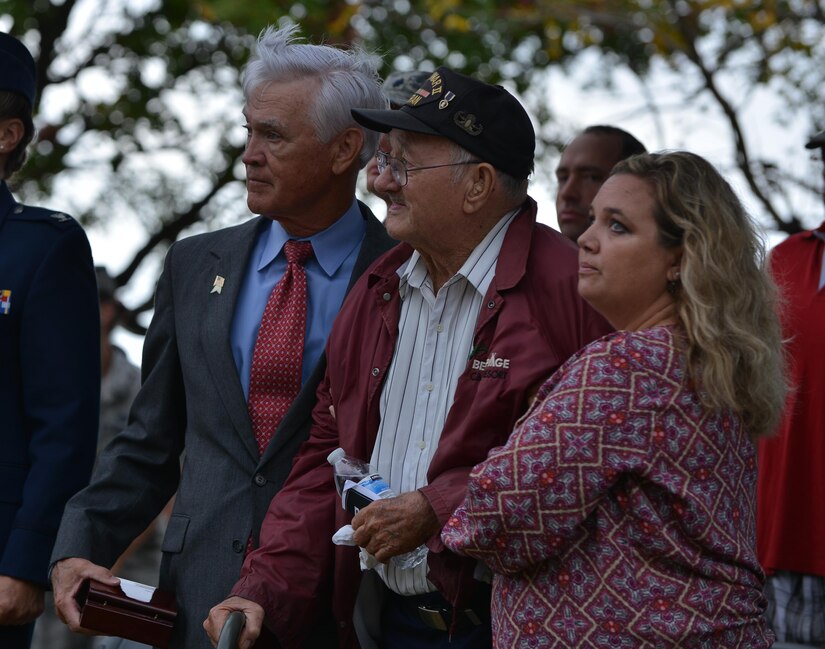 Retired U.S. Air Force Lt. Col. Barry B. Bridger, left, former Vietnam War prisoner of war, Allen Ordorff, a World War II veteran, and Orndorff’s neighbor Amanda Atwell stand to pay honor to POW/MIA at the POW/MIA Recognition Day ceremony at Joint Base Langley-Eustis, Va., Sept. 16, 2016. Bridger and Ordorff shared their stories of witnessing atrocities of the Vietnam and World Wars. (U.S. Air Force photo by Staff Sgt. Natasha Stannard)