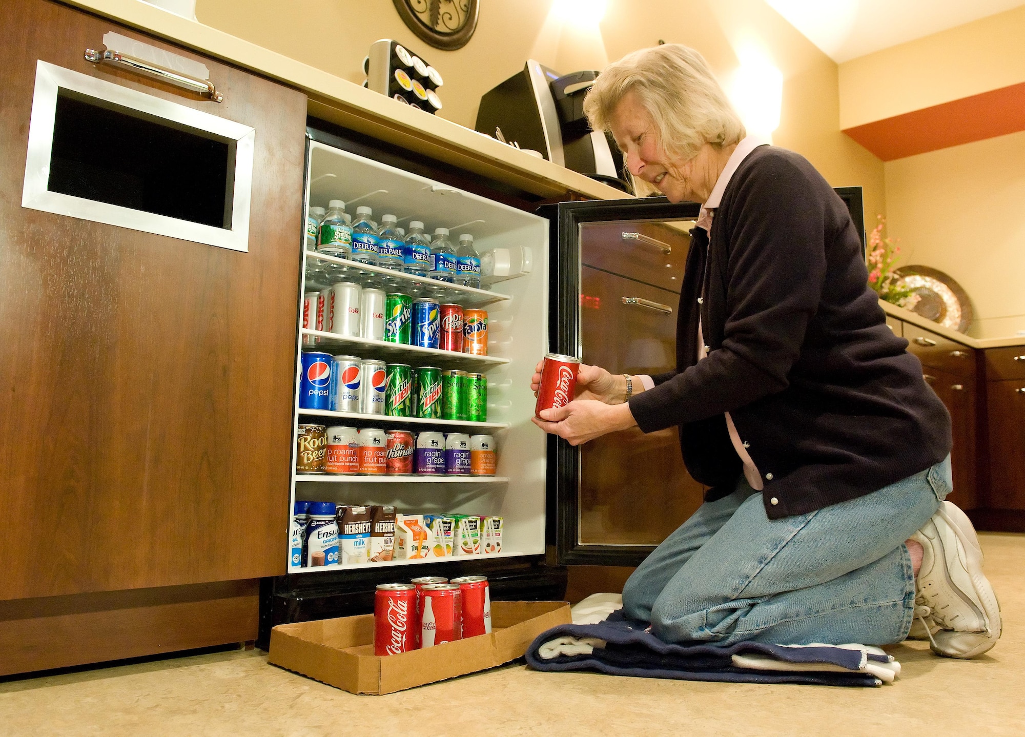 Janet King, Friends of the Fallen donation coordinator, checks the expiration date on sodas in the Center for Families of the Fallen March 31, 2016. King manages the organization’s inventory of support material ranging from grief material and comfort items to food and drinks for families attending dignified transfers. (U.S. Air Force photo/Roland Balik)