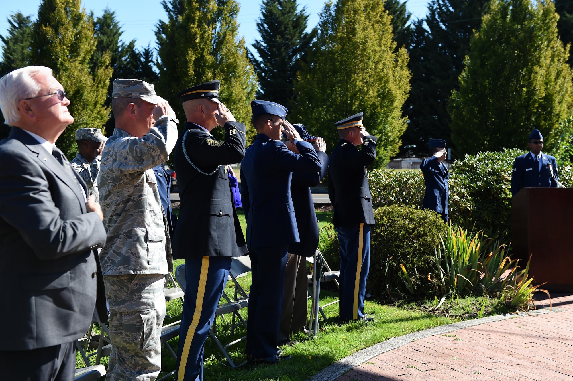 62nd Airlift Wing leadership and special guests salute during the National Anthem at the Prisoner of War/Missing in Action wreath laying ceremony September 12, 2016 at Joint Base Lewis-McChord, Wash. The ceremony began the weeks’ worth of events in honor of our POWs and MIA brothers and sisters in arms. (U.S. Air Force photo/Staff Sgt. Naomi Shipley)