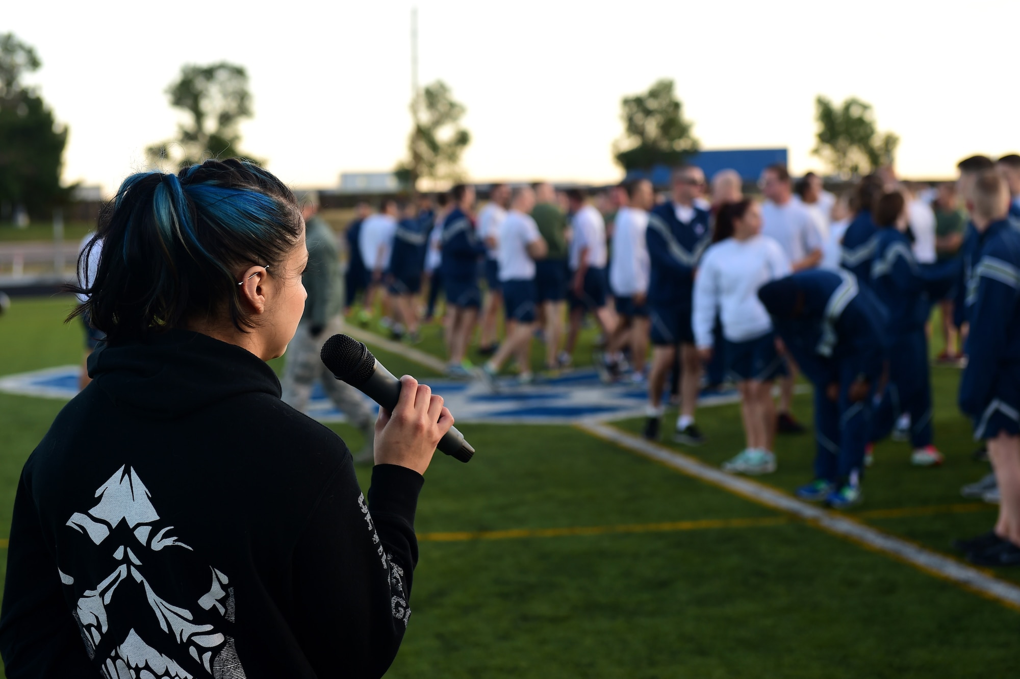 Azul Farrera, 460th Force Support Squadron recreation assistant, instructs Warfit participants after a 24-hour POW/MIA memorial run Sept. 16, 2016, at an outdoor track on Buckley Air Force Base, Colo. Warfit provided an opportunity for all members of Team Buckley to come together and participate in a workout designed by fitness center instructors. (U.S. Air Force photo by Airman 1st Class Gabrielle Spradling/Released)