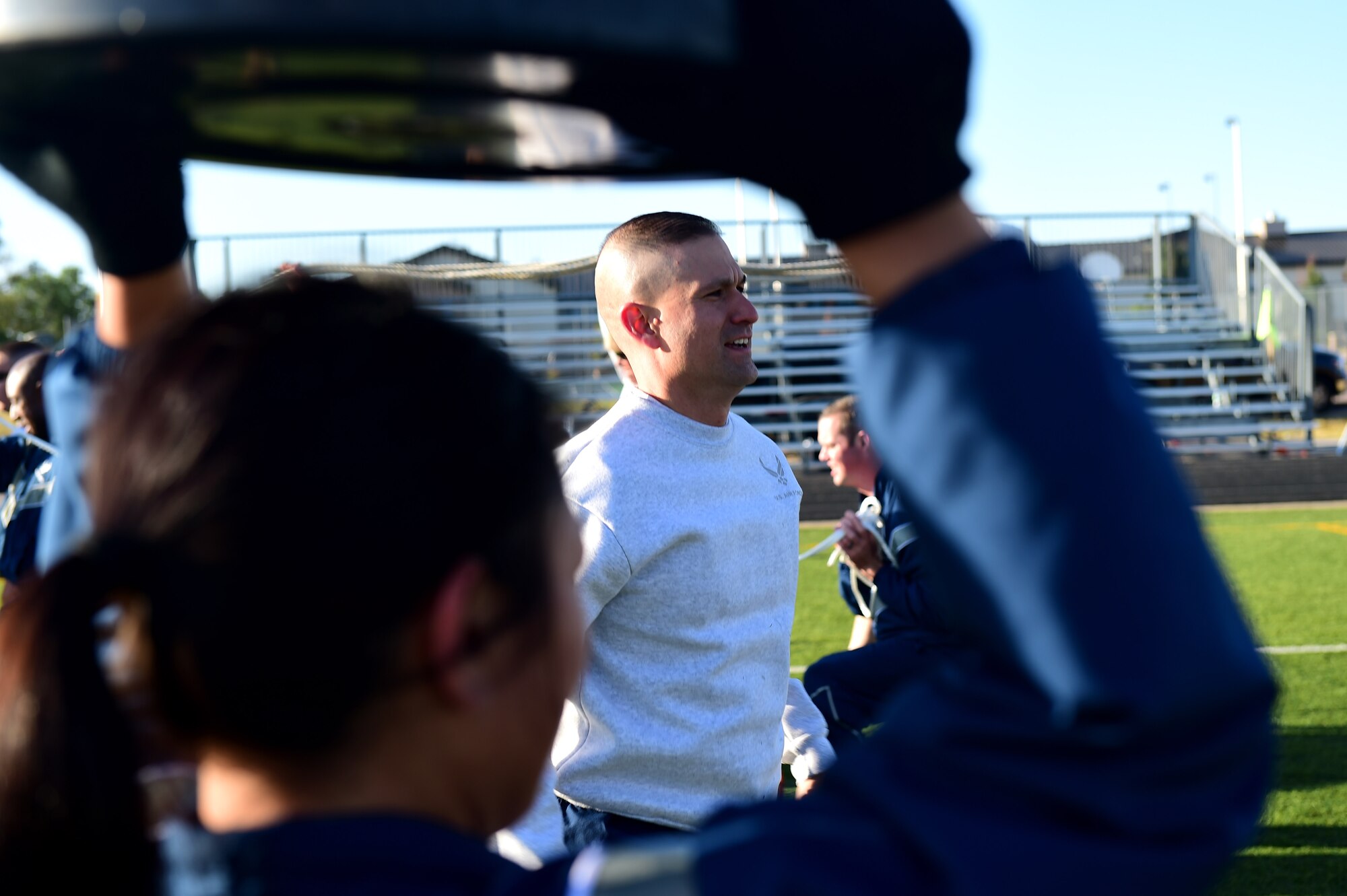 Team Buckley members participate in Warfit after a 24-hour POW/MIA memorial run Sept. 16, 2016, at an outdoor track on Buckley Air Force Base, Colo. Warfit provided an opportunity for all members of Team Buckley to come together and participate in a workout designed by fitness center instructors. (U.S. Air Force photo by Airman 1st Class Gabrielle Spradling/Released)