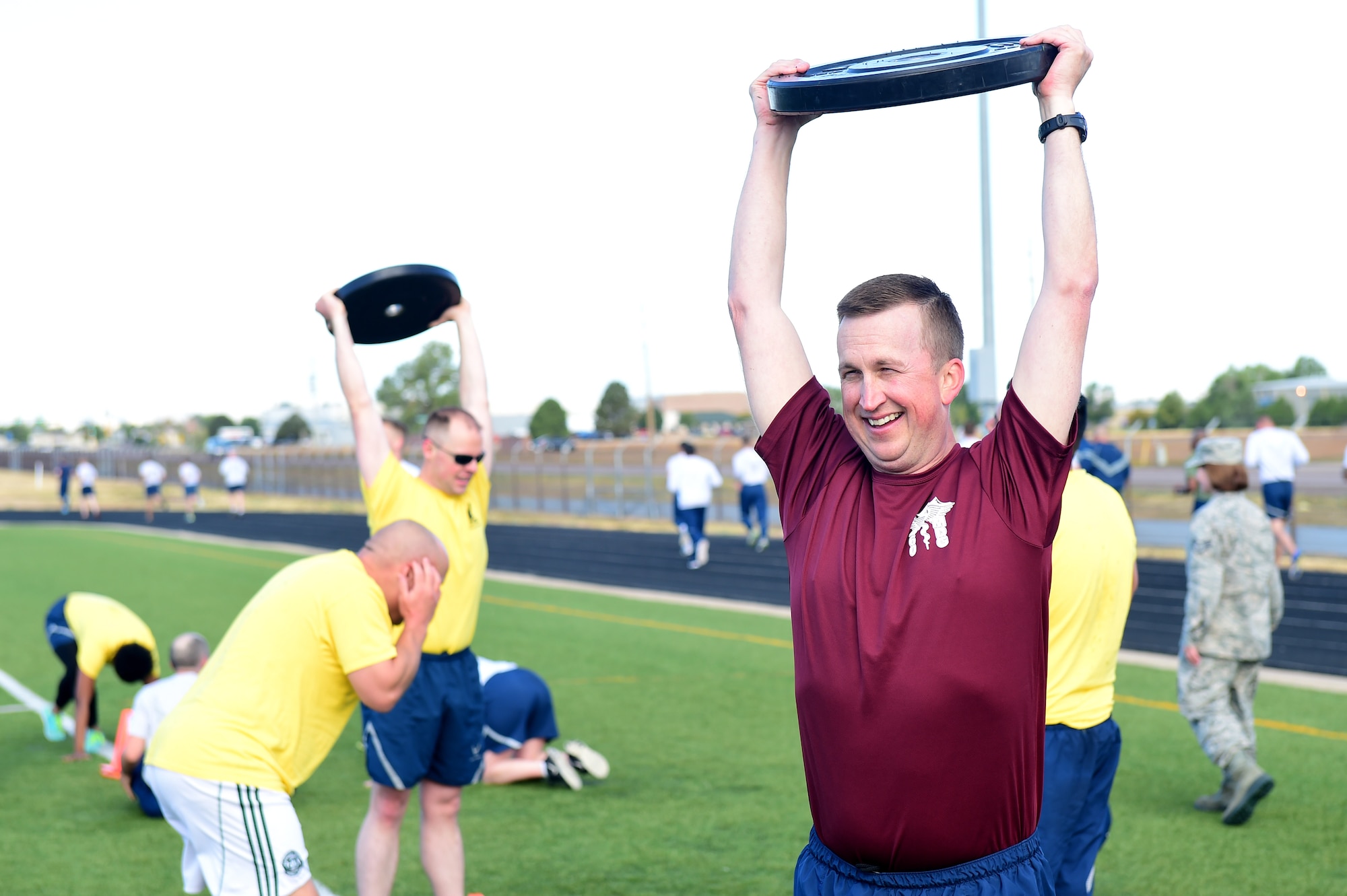 Col. Matthew Hanson, 460th Medical Group commander, participates in Warfit after a 24-hour POW/MIA memorial run Sept. 16, 2016, at the outdoor track on Buckley Air Force Base, Colo. Warfit provides an opportunity for all members of Team Buckley to come together and participate in a workout designed by the fitness center instructors. (U.S. Air Force photo by Airman 1st Class Gabrielle Spradling/Released)