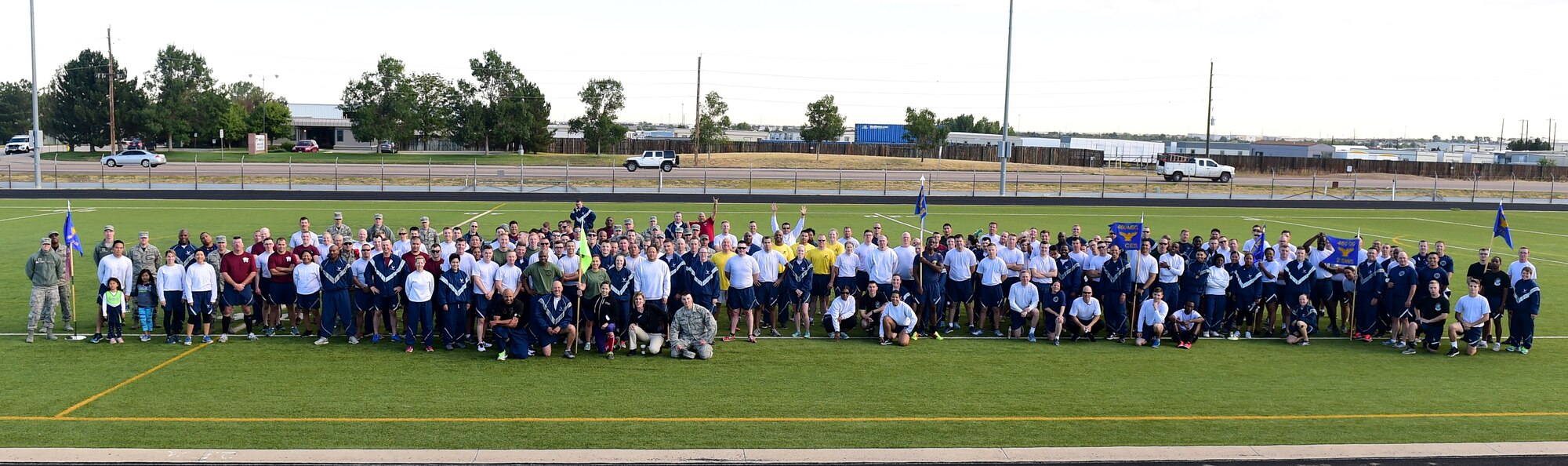 Team Buckley comes together after participating in a Warfit workout Sept. 16, 2016, at an outdoor track on Buckley Air Force Base, Colo. Warfit provided an opportunity for all members of Team Buckley to come together and participate in a workout designed by fitness center instructors. (U.S. Air Force photo by Airman 1st Class Gabrielle Spradling/Released)