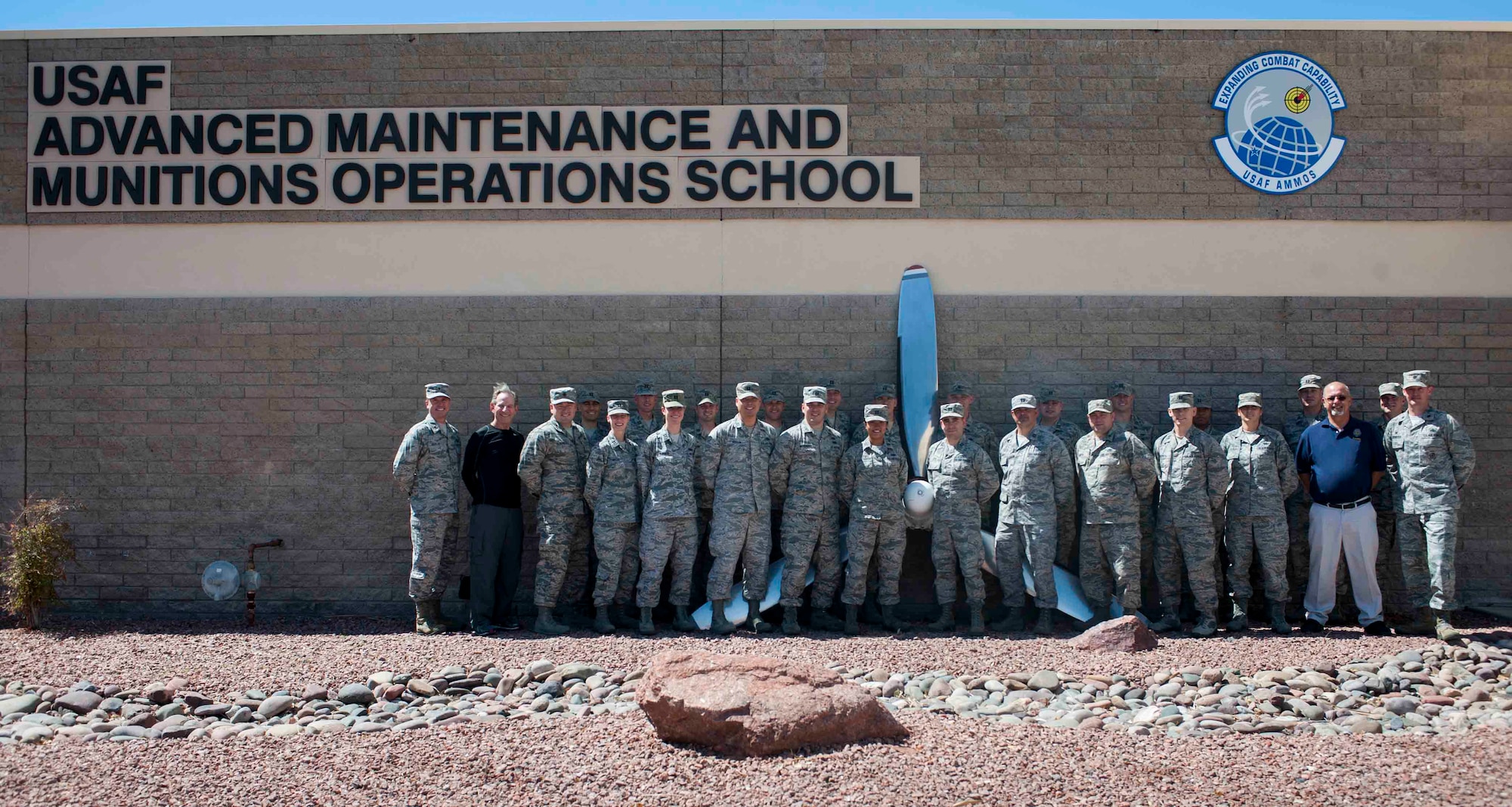 Students and cadre of the Advanced Sortie Production Course at the U.S. Air Force Advanced Maintenance and Munitions Operations School on Nellis Air Force Base, Nev., pose for a group photo Sept. 13, 2016. Throughout the inaugural 12 week course, the ASPC will provide graduate level instruction to develop highly skilled officers in the art of sortie production processes at the tactical level. (U.S. Air Force photo by Senior Airman Jake Carter)