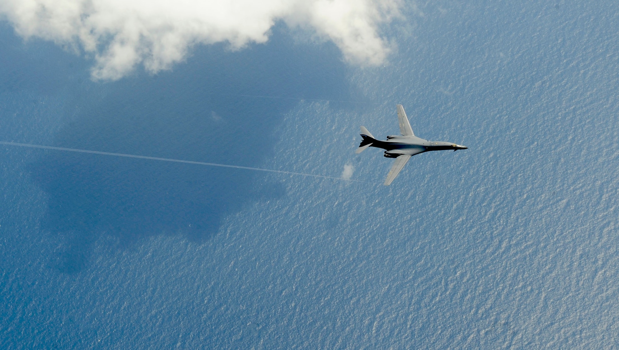 A B-1B Lancer from Dyess Air Force Base, Texas, flies over the Atlantic Ocean before refueling from a KC-135 assigned to the 100th Air Refueling Wing, Royal Air Force Mildenhall, England, July 31, 2012. The B-1, commonly referred to as the “Bone,” is exceptionally versatile and has a synthetic aperture radar that is capable of tracking, targeting and engaging moving vehicles as well as self-targeting and terrain-following modules. (U.S. Air Force photo/Senior Airman Ethan Morgan)