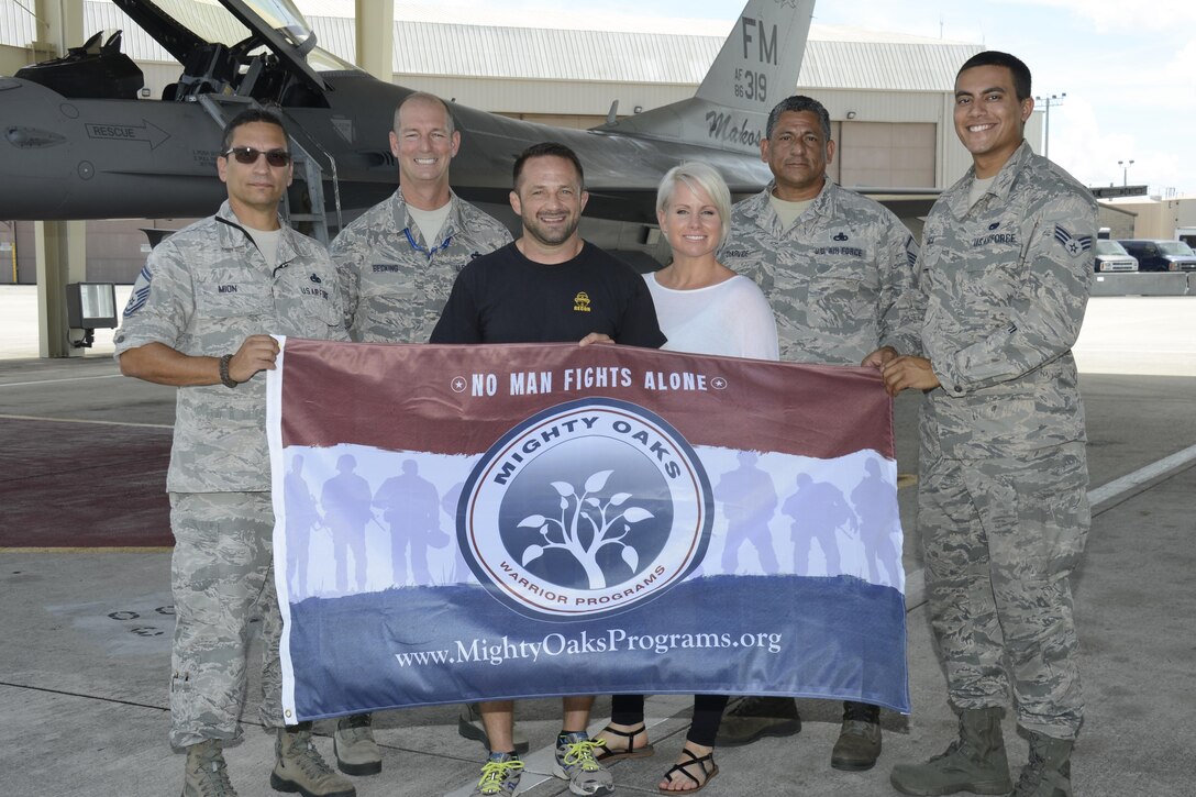 Chad Robichaux, the Mighty Oaks Warrior Program founder, poses for a photo with crew chiefs after speaking to more than 1,000 Airmen during Wingman Day in the Sam Johnson Fitness Center, Sept. 10. Robichaux’s program helps veterans with PTSD, pre and post deployers, and struggling marriages. (U.S. Air Force photo by Senior Airman Frank Casciotta)