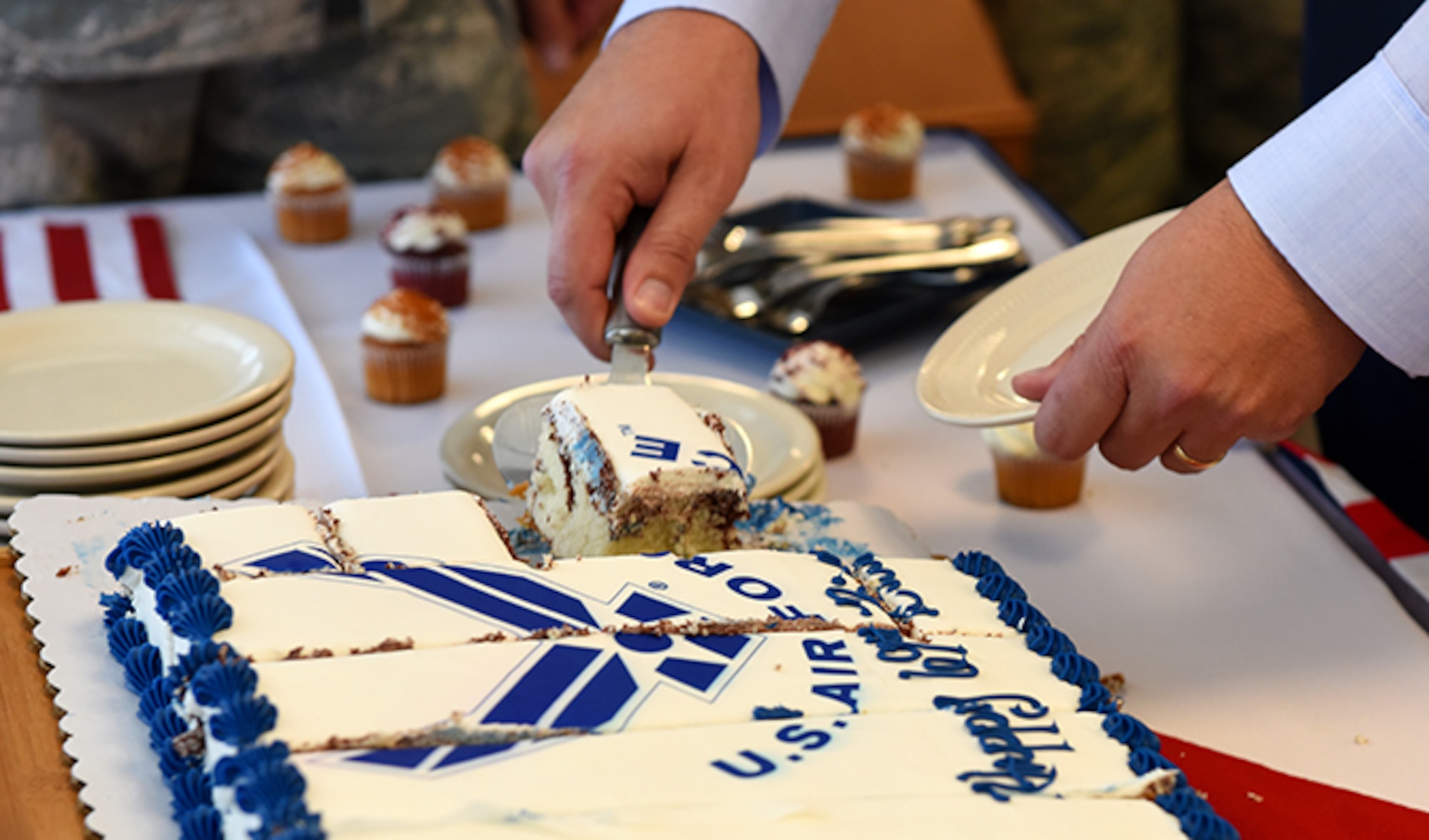 Col. Matthew Fritz, 92nd Air Refueling Wing vice commander, serves up slices of birthday cake at a United States Air Force birthday ceremony Sept. 13, at Fairchild Air Force Base. The base spent the week recognizing the USAF's birthday with several ceremonies. (U.S. Air Force photo/Airman 1st Class Ryan Lackey)