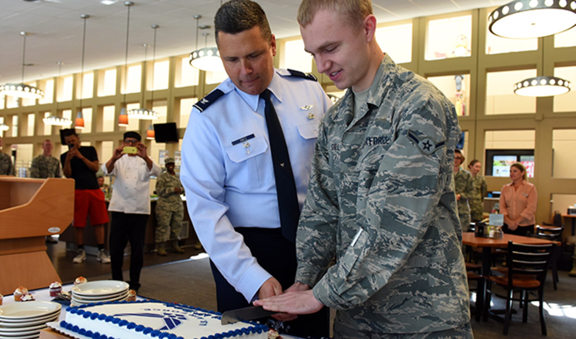 Col. Matthew Fritz, 92nd Air Refueling Wing vice commander and Airman Caleb Grill, 92nd Force Support Squadron services apprentice, cuts the United States Air Force birthday cake during a ceremony Sept. 13, 2016, at Fairchild Air Force Base. Grill was the youngest one present and was accorded the traditional honor of cutting the cake. (U.S. Air Force photo/Airman 1st Class Ryan Lackey)
