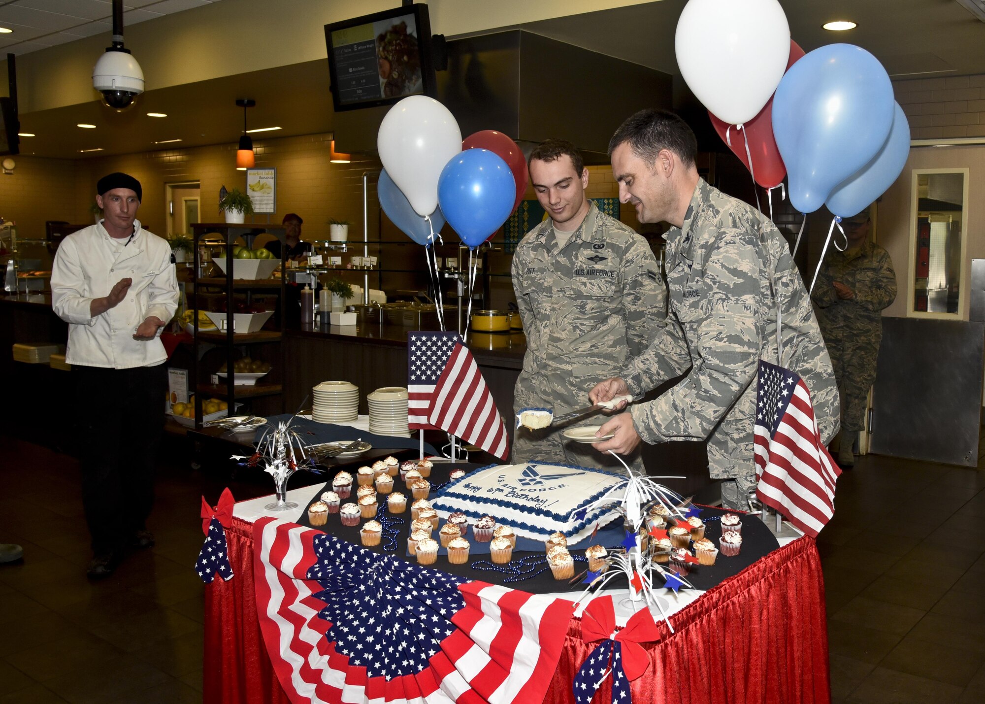 Col. John Groves, 336th Training Group commander, serves a piece of cake to Airman 1st Class Logan Pitt, 336th Training Support Squadron aircrew flight equipment apprentice, during a cake cutting ceremony Sept. 15, 2016, at Fairchild Air Force Base, Wash. The ceremony was to celebrate the 69th birthday of the Air Force. 