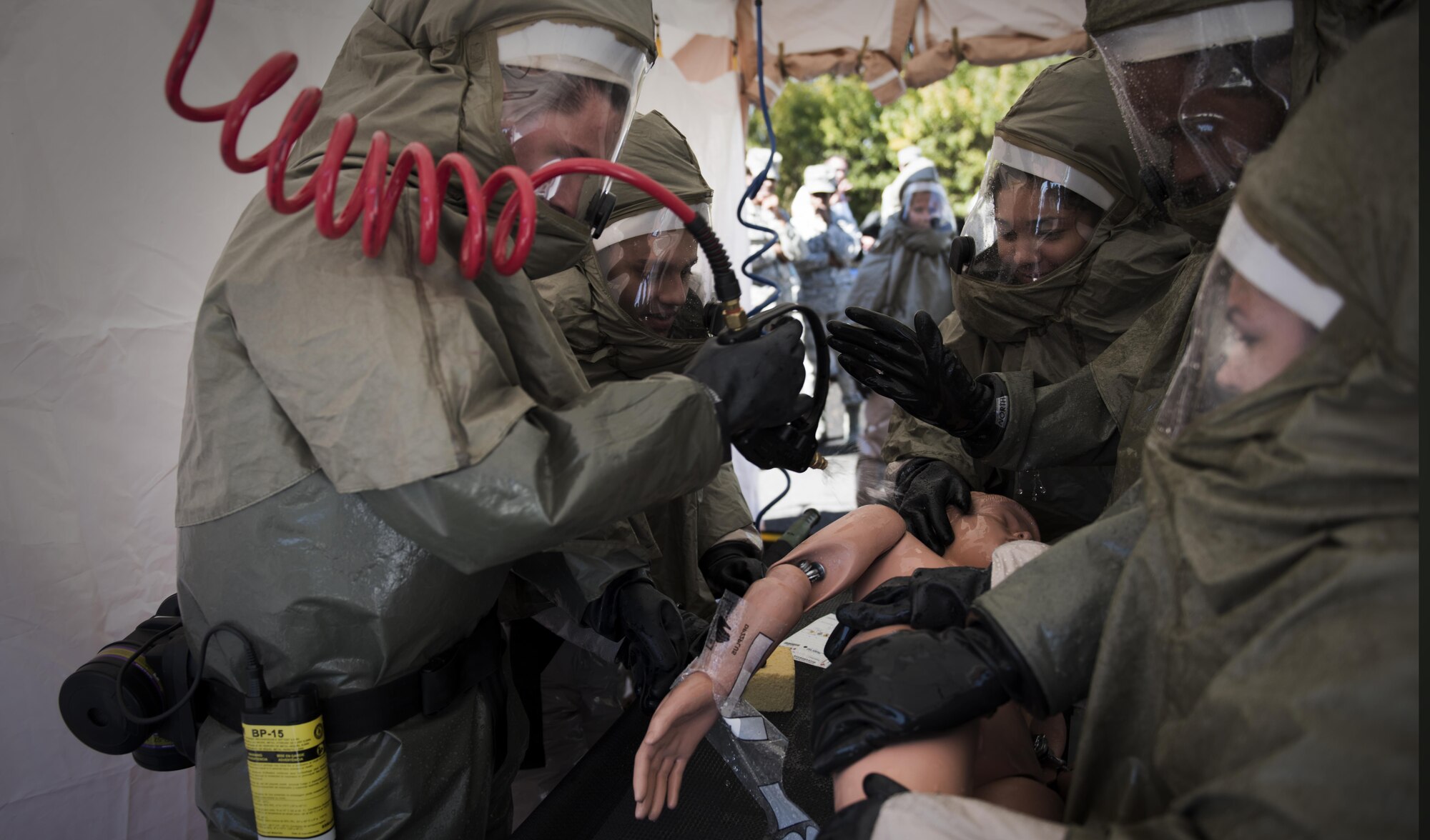 Fairchild Airmen conduct a non-ambulatory patient decontamination during a mock decontamination training exercise Sept. 16, 2016, at Fairchild Air Force Base, Wash. The biannual training is broken up into six hours of lectures, two hours of personal-protective equipment training, a one hour written exam, six hours of hands-on equipment training and one hour of equipment cleaning. (U.S. Air Force photo/Airman 1st Class Sean Campbell)