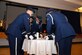 The Beale Air Force Base Honor Guard places the service covers of all the branches of the military on a table to honor the service members who were prisoners of war or those who remain missing in action at the POW/MIA ceremonial breakfast Sept. 15, 2016, at Beale Air Force Base, California. More than 82,000 American service members are still considered missing in action. (U.S. Air Force photo/Airman Tristan D. Viglianco)