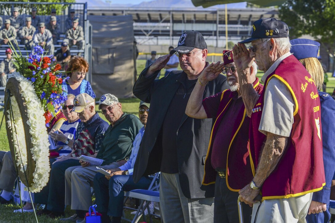 Former prisoners of war salute a wreath during a National POW/MIA Recognition Day ceremony at Freedom Park at Nellis Air Force Base, Nev., Sept. 16, 2016. Air Force photo by Airman 1st Class Nathan Byrnes