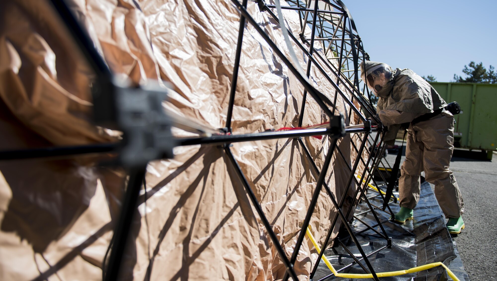 A Fairchild Airman helps set up a decontamination tent during a mock decontamination training exercise Sept. 16, 2016, at Fairchild Air Force Base, Wash. Part of the In-Place Patient Decontamination team’s responsibility is to process ambulatory and non-ambulatory patients who have been exposed to a foreign substance and remove any contaminates before giving them access to the clinic or receiving further medical treatment. (U.S. Air Force photo/Airman 1st Class Sean Campbell)