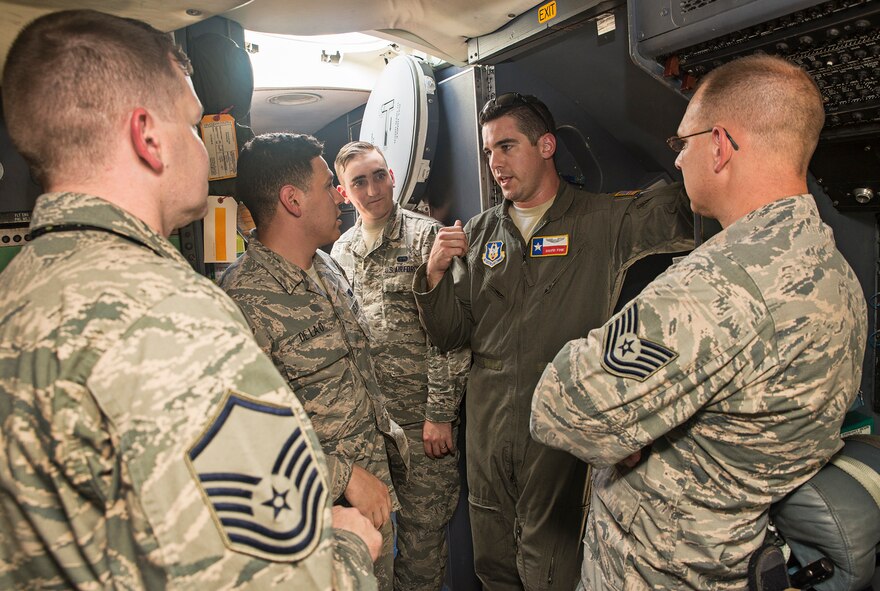 First Lt. David Fink, 68th Airlift Squadron C-5M Super Galaxy pilot, describes the amount of training it takes to be qualified to fly the massive cargo aircraft with Airmen of the 690th Network Support Squadron Sept. 13, 2016 at Joint Base San Antonio-Lackland, Texas. While Airmen of the 690th NSS are stationed at JBSA-Lackland alongside the 68th AS, this was the first time many of them have had the opportunity to see the Air Force's largest cargo aircraft up close.  (U.S. Air Force photo by Benjamin Faske)