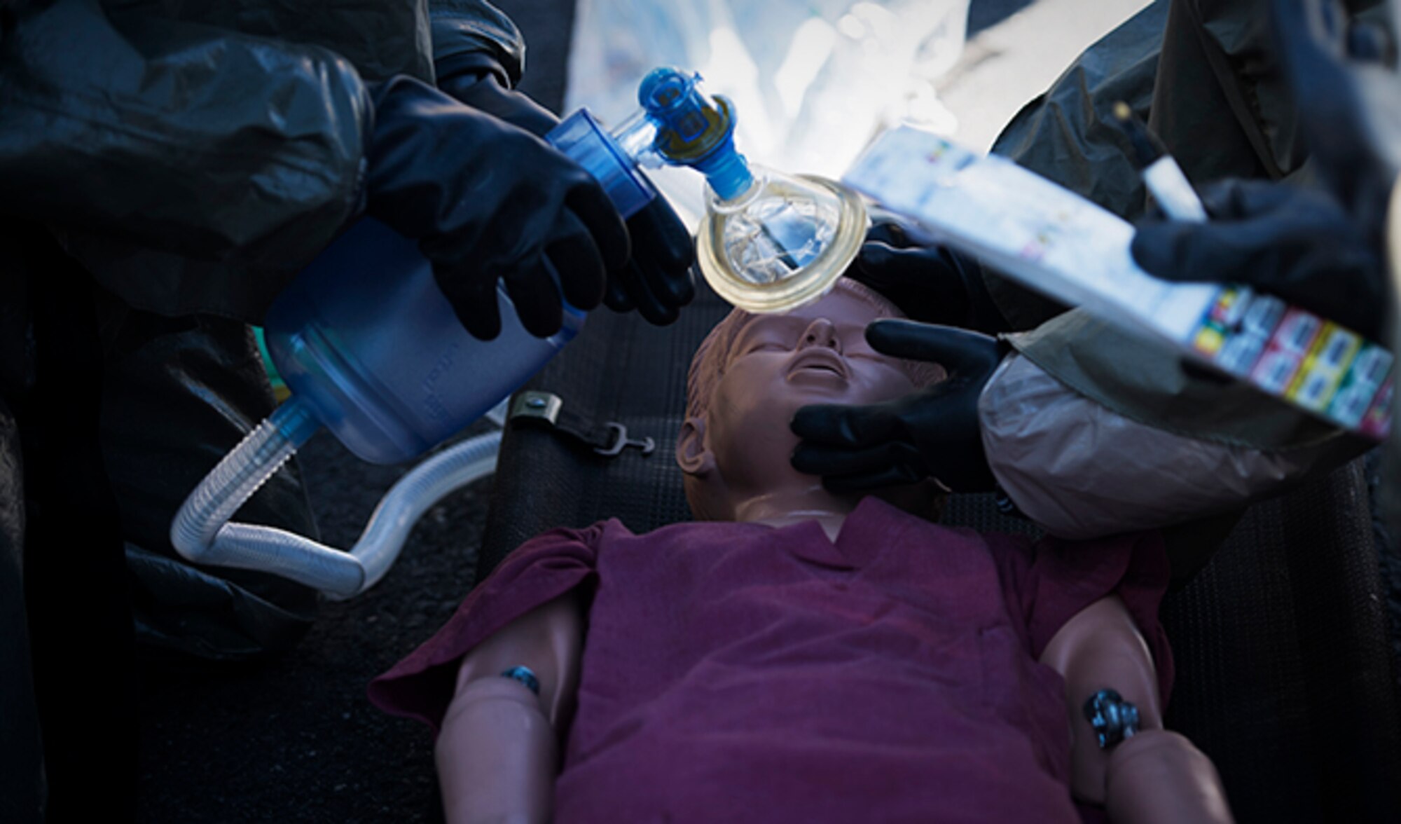 Fairchild Airmen simulate making sure the patient is breathing during a mock decontamination training exercise Sept. 16, 2016, at Fairchild Air Force Base, Wash. Decontamination is the process of removing surface contaminants on a person or piece of equipment. This process reduces the spread of hazardous agents to other people. (U.S. Air Force photo/Airman 1st Class Sean Campbell)
