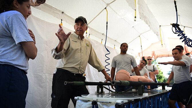 Charlie Jansen, a decontamination instructor, walks Fairchild Airmen through what they will be doing for the decontamination training exercise Sept. 16, 2016, at Fairchild Air Force Base, Wash. The Air Force contracts instructors to come and teach bases biannually making sure that Airmen have the best training possible. (U.S. Air Force photo/Airman 1st Class Sean Campbell)