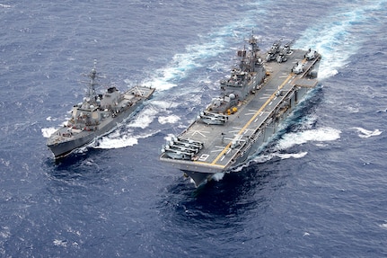 The Arleigh Burke-class guided-missile destroyer USS Curtis Wilber (DDG 54) steams alongside amphibious assault ship USS Bonhomme Richard (LHD 6) during a fueling at sea (FAS), Sept. 15, 2016. Bonhomme Richard, flagship of the Bonhomme Richard Expeditionary Strike Group, is operating in the Philippine Sea in support of security and stability in the Indo-Asia Pacific region.