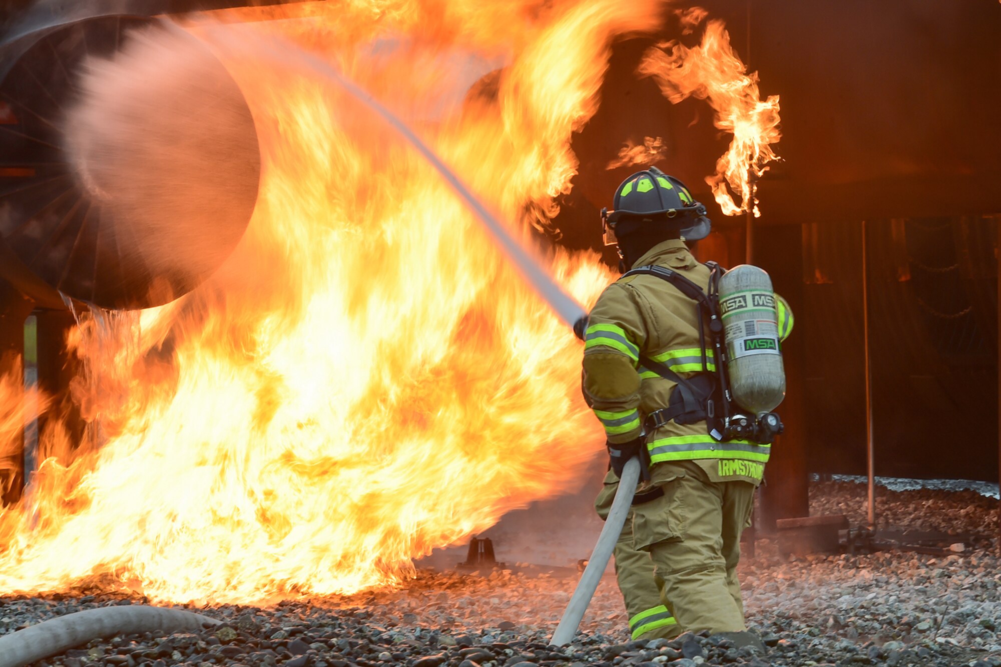 Fire protection specialist Airmen assigned to the 673rd Civil Engineer Squadron perform firefighter training on a simulated aircraft fire at Joint Base Elmendorf-Richardson, Alaska, Wednesday, Sept. 14, 2016.  Aircraft live fire training is conducted periodically throughout the year at JBER to ensure Airmen are prepared to combat aircraft fuel fires.