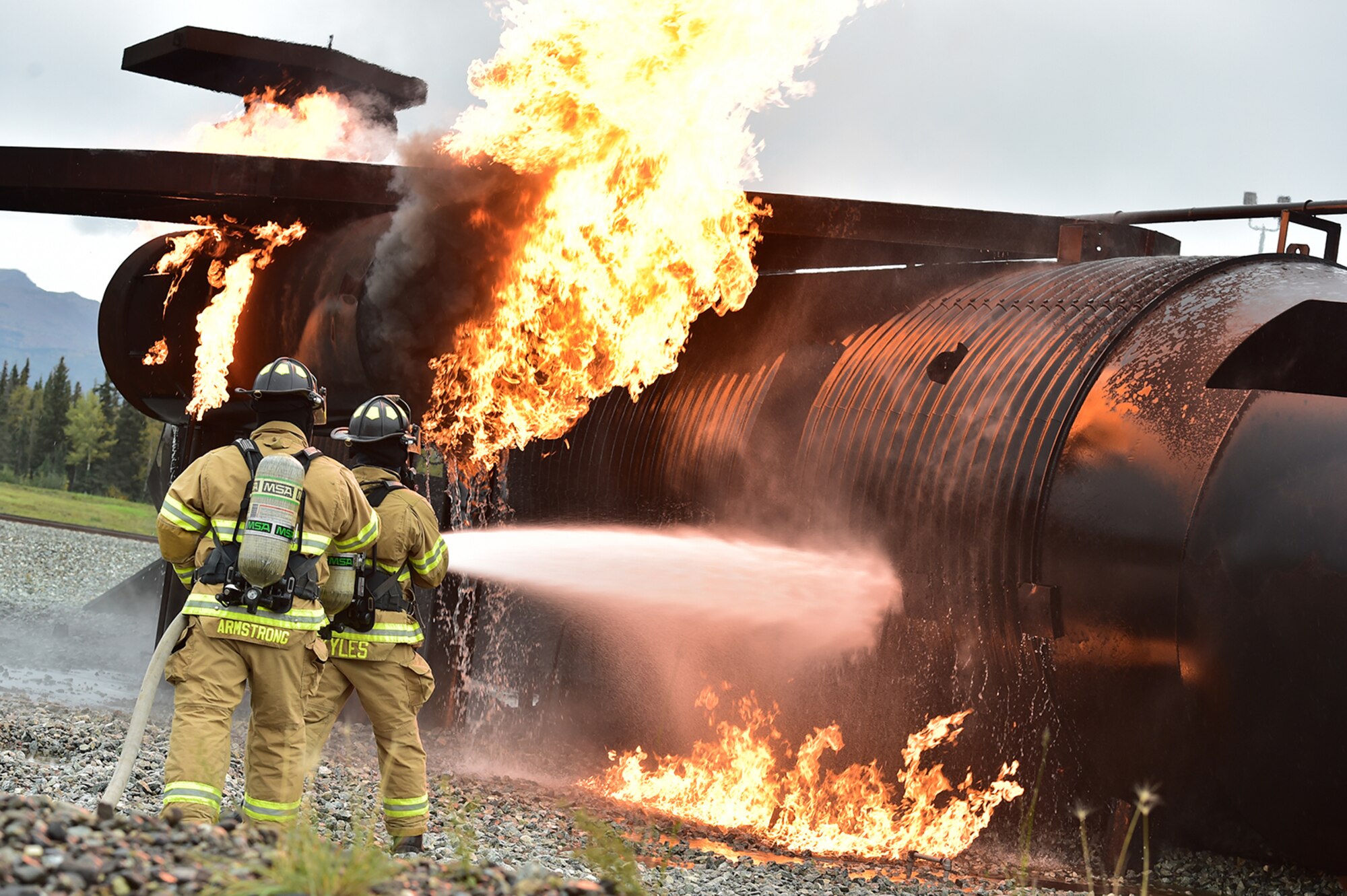 Fire protection specialist Airmen assigned to the 673rd Civil Engineer Squadron perform firefighter training on a simulated aircraft fire at Joint Base Elmendorf-Richardson, Alaska, Wednesday, Sept. 14, 2016.  Aircraft live fire training is conducted periodically throughout the year at JBER to ensure Airmen are prepared to combat aircraft fuel fires.