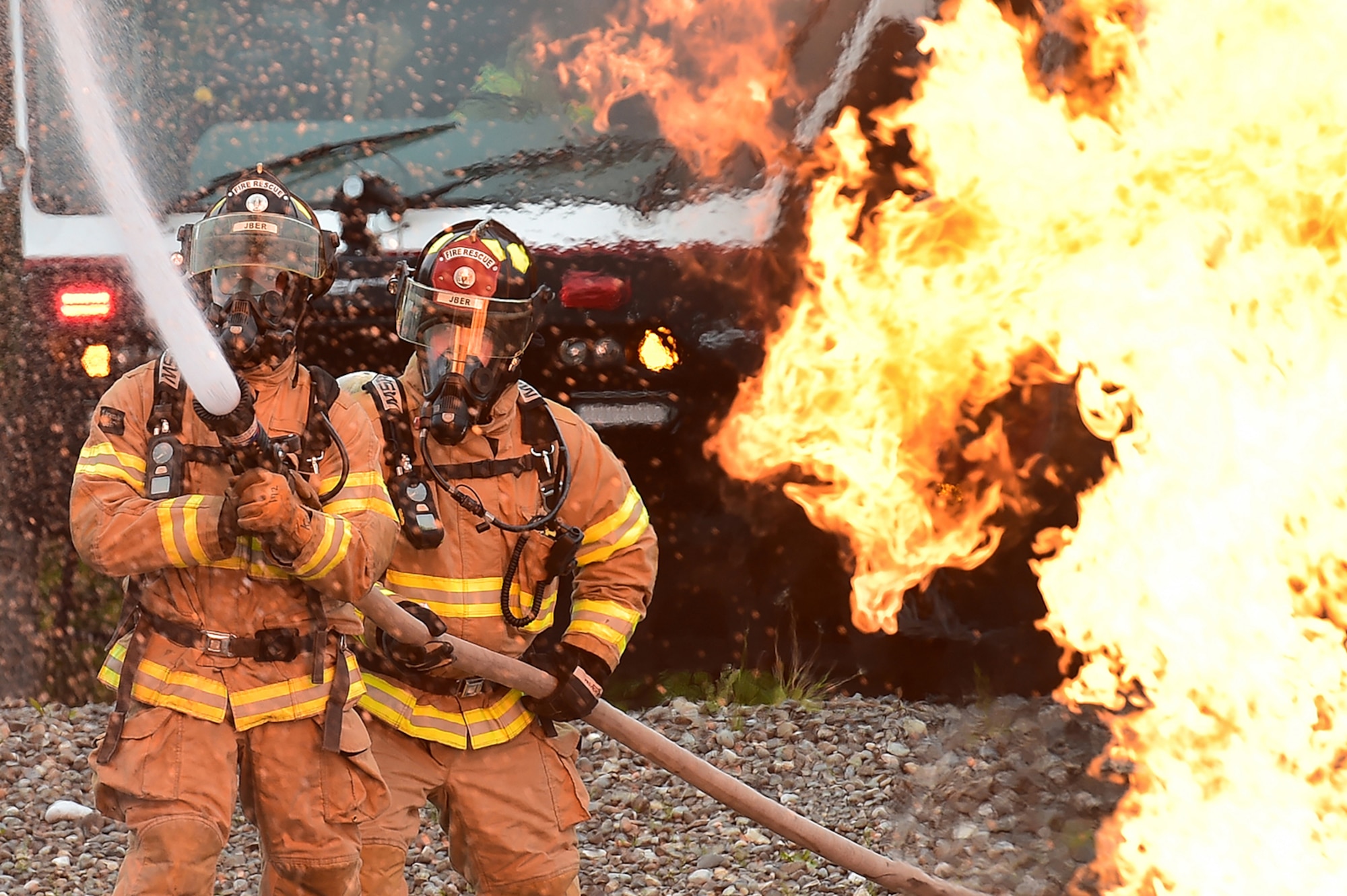 Fire protection specialist Airmen assigned to the 673rd Civil Engineer Squadron perform firefighter training on a simulated aircraft fire at Joint Base Elmendorf-Richardson, Alaska, Wednesday, Sept. 14, 2016.  Aircraft live fire training is conducted periodically throughout the year at JBER to ensure Airmen are prepared to combat aircraft fuel fires.