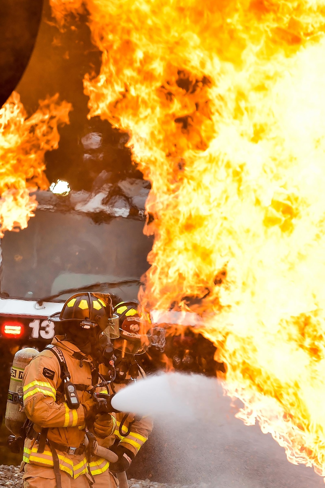 Fire protection specialist Airmen assigned to the 673rd Civil Engineer Squadron perform firefighter training on a simulated aircraft fire at Joint Base Elmendorf-Richardson, Alaska, Wednesday, Sept. 14, 2016.  Aircraft live fire training is conducted periodically throughout the year at JBER to ensure Airmen are prepared to combat aircraft fuel fires.