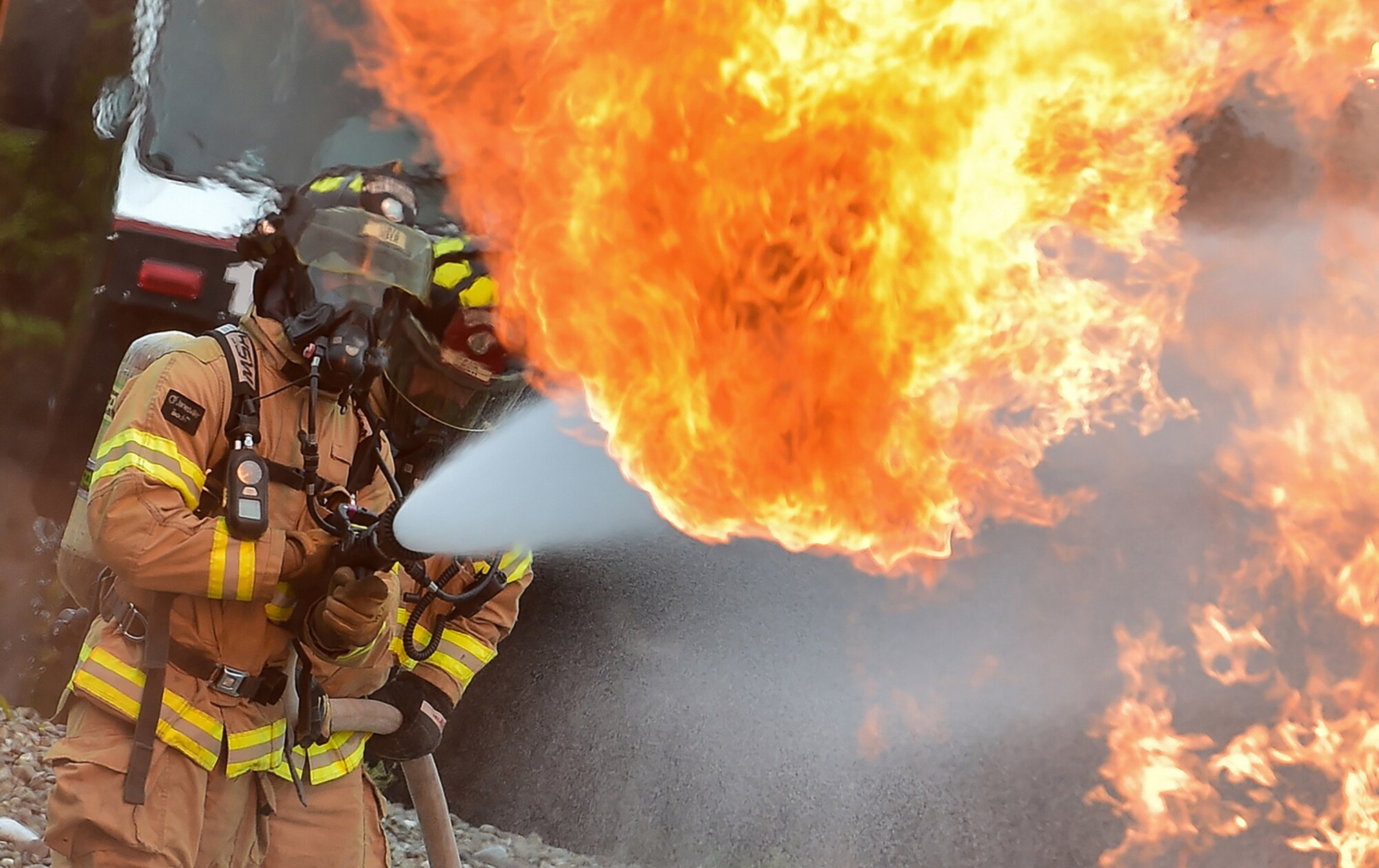 Fire protection specialist Airmen assigned to the 673rd Civil Engineer Squadron perform firefighter training on a simulated aircraft fire at Joint Base Elmendorf-Richardson, Alaska, Wednesday, Sept. 14, 2016.  Aircraft live fire training is conducted periodically throughout the year at JBER to ensure Airmen are prepared to combat aircraft fuel fires.