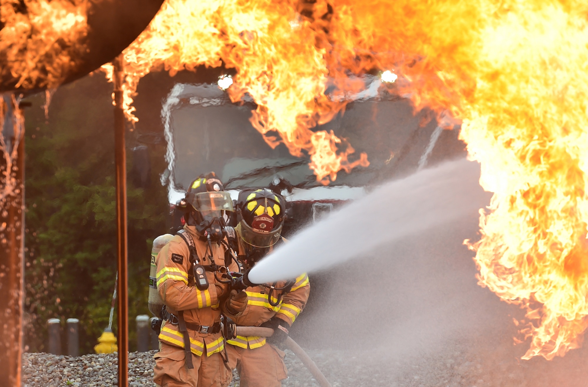 Fire protection specialist Airmen assigned to the 673rd Civil Engineer Squadron perform firefighter training on a simulated aircraft fire at Joint Base Elmendorf-Richardson, Alaska, Wednesday, Sept. 14, 2016.  Aircraft live fire training is conducted periodically throughout the year at JBER to ensure Airmen are prepared to combat aircraft fuel fires. 