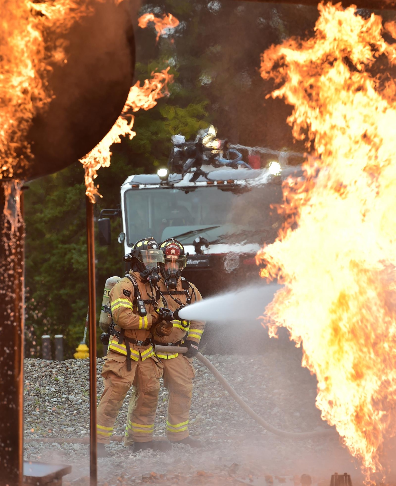 Fire protection specialist Airmen assigned to the 673rd Civil Engineer Squadron perform firefighter training on a simulated aircraft fire at Joint Base Elmendorf-Richardson, Alaska, Wednesday, Sept. 14, 2016.  Aircraft live fire training is conducted periodically throughout the year at JBER to ensure Airmen are prepared to combat aircraft fuel fires.