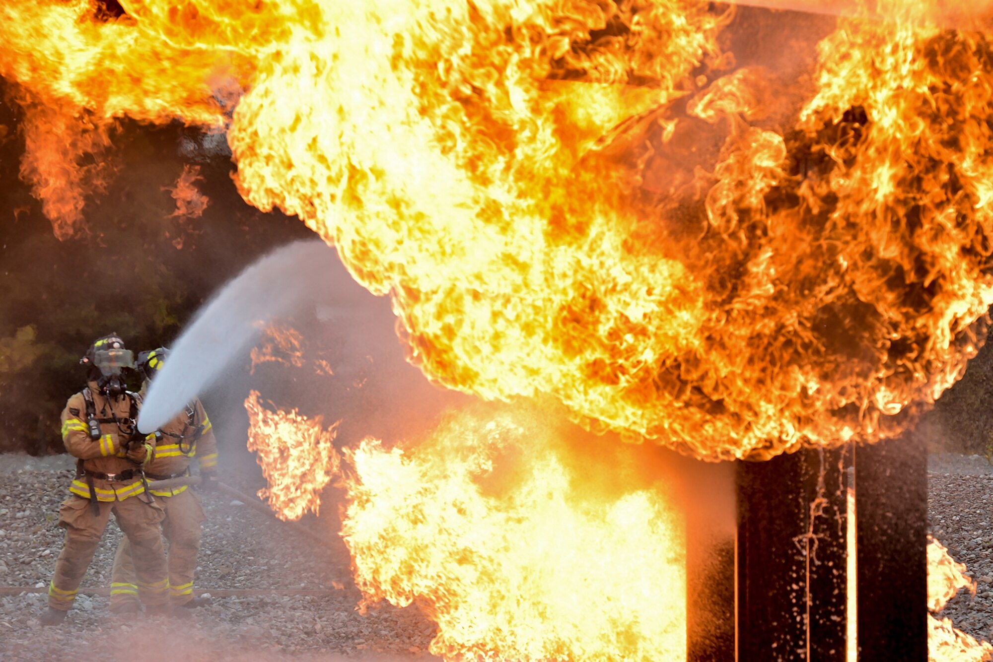 Fire protection specialist Airmen assigned to the 673rd Civil Engineer Squadron perform firefighter training on a simulated aircraft fire at Joint Base Elmendorf-Richardson, Alaska, Wednesday, Sept. 14, 2016.  Aircraft live fire training is conducted periodically throughout the year at JBER to ensure Airmen are prepared to combat aircraft fuel fires.