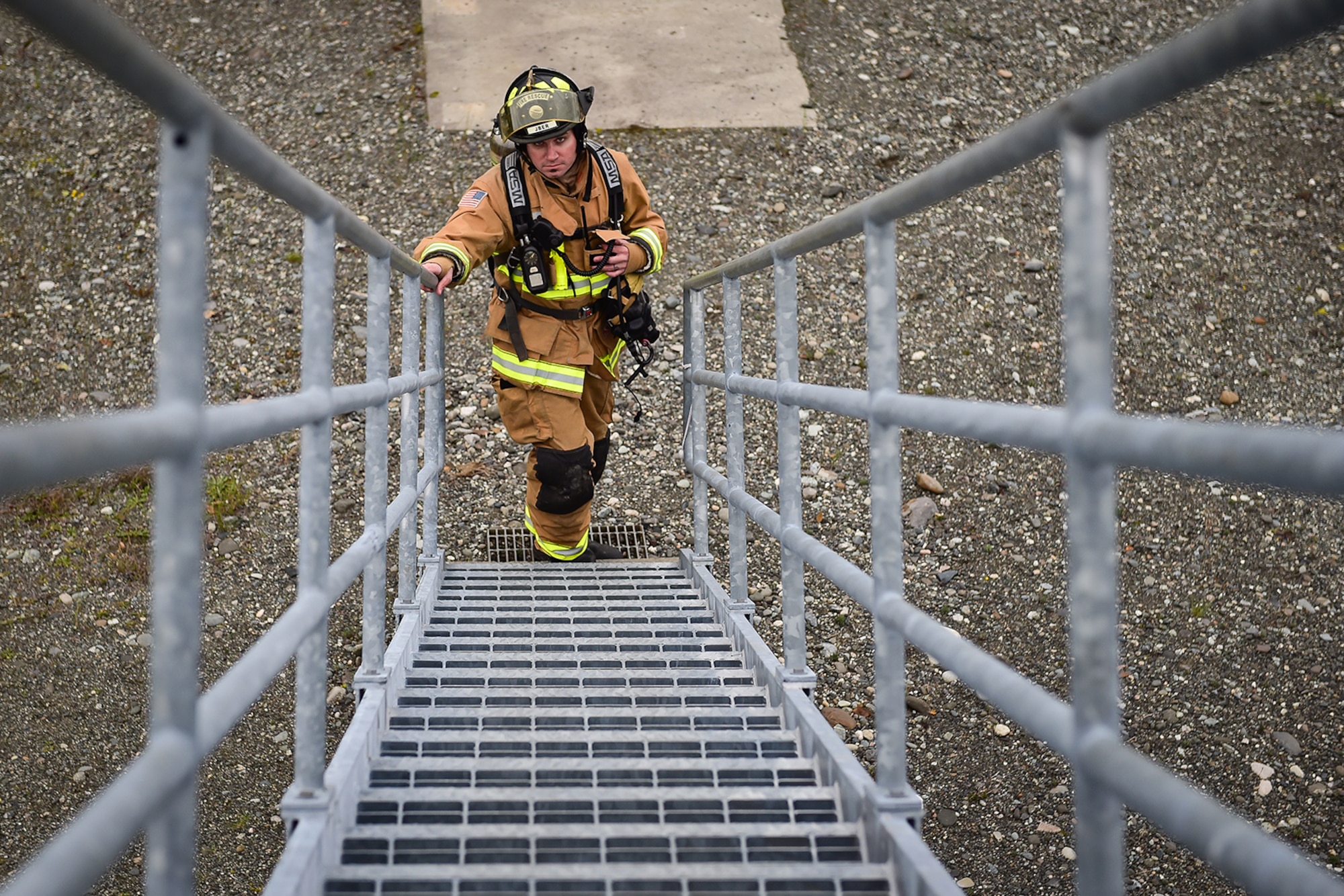 Civilian Airman firefighter Jason McKnight, assigned to the 673rd Civil Engineer Squadron, waits for the order to begin firefighter training on a simulated aircraft fire at Joint Base Elmendorf-Richardson, Alaska, Wednesday, Sept. 14, 2016.  Aircraft live fire training is conducted periodically throughout the year at JBER to ensure Airmen are prepared to combat aircraft fuel fires. 