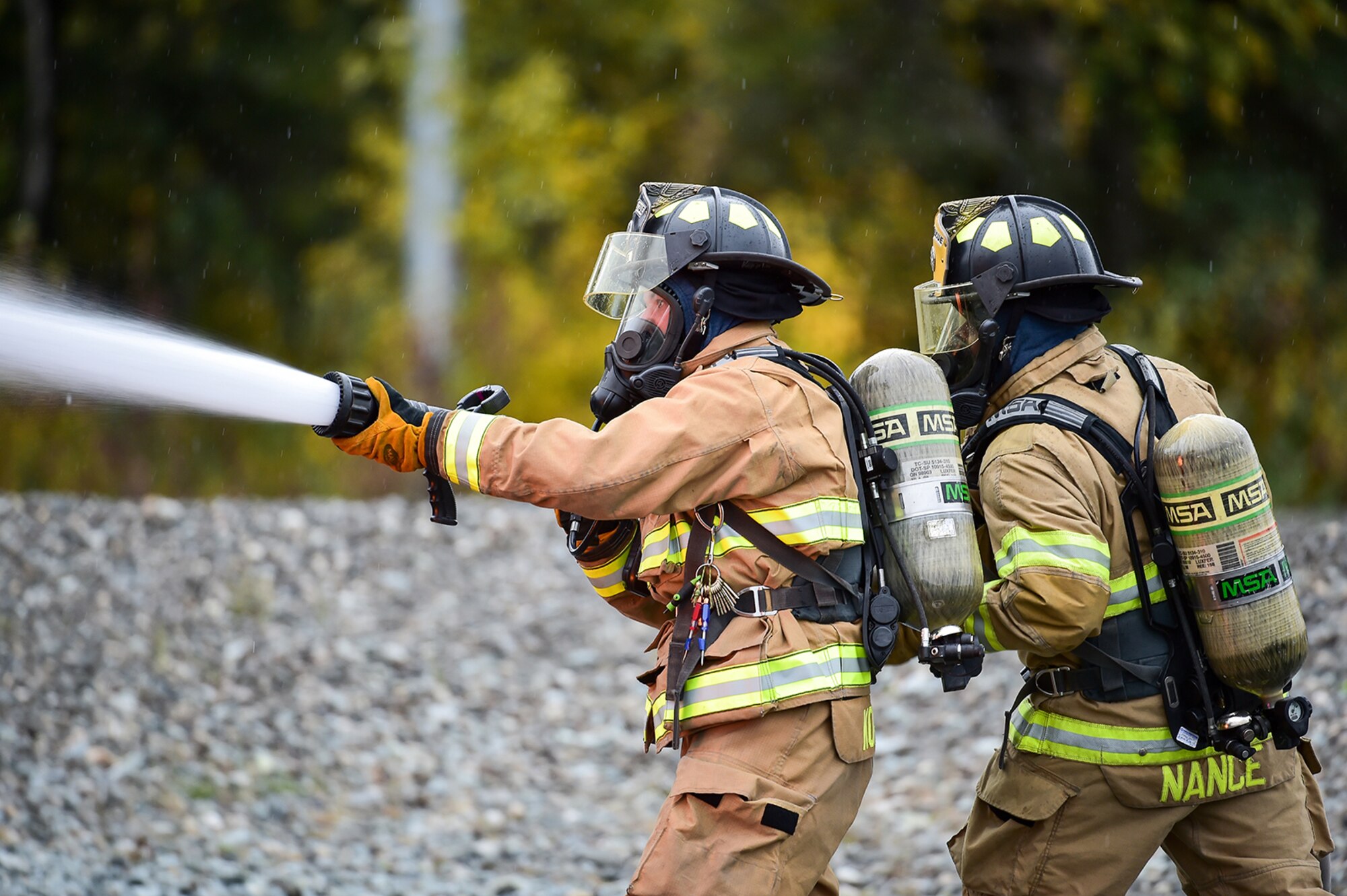 Fire protection specialist Airmen assigned to the 673rd Civil Engineer Squadron perform firefighter training on a simulated aircraft fire at Joint Base Elmendorf-Richardson, Alaska, Wednesday, Sept. 14, 2016.  Aircraft live fire training is conducted periodically throughout the year at JBER to ensure Airmen are prepared to combat aircraft fuel fires.