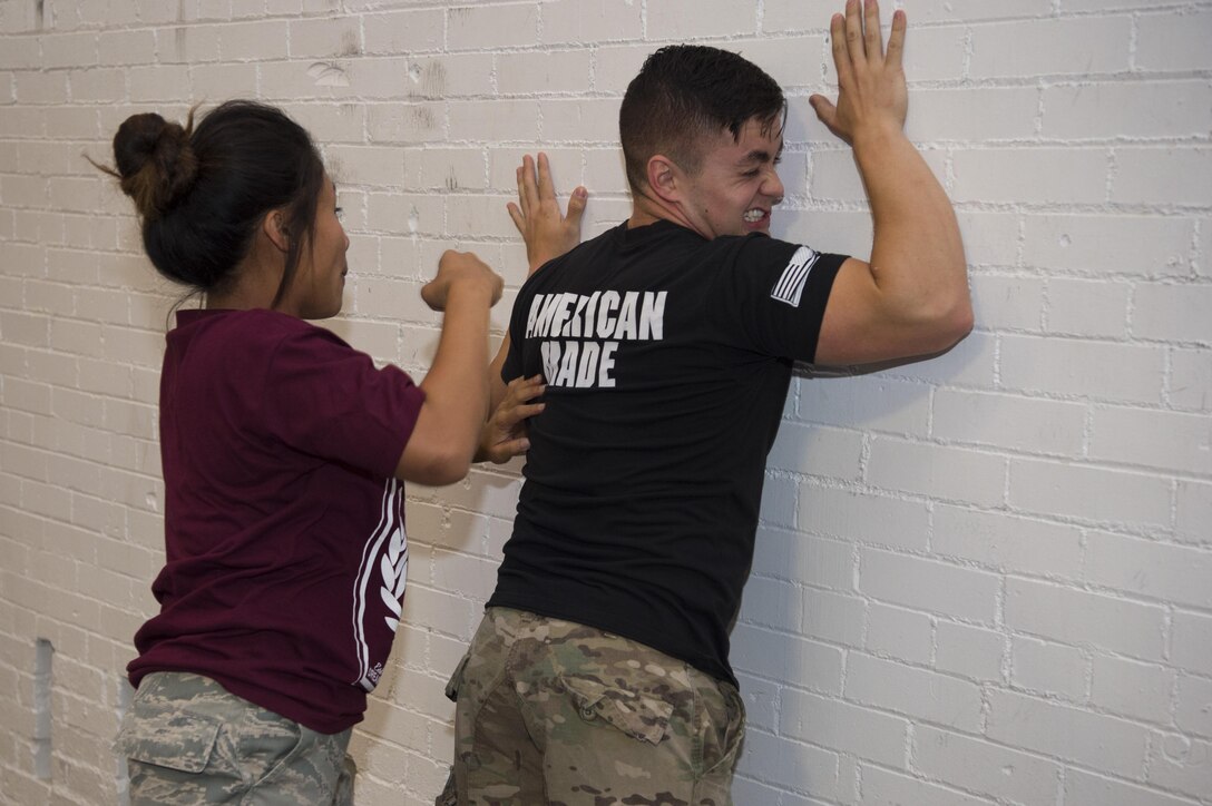 Senior Airman Shaila Melegrito, 377th Weapons Systems Security Squadron underground munitions maintenance and storage complex entry controller, throws Senior Airman Clayton Foster, 790th Missile Security Forces Squadron dispatcher, against the wall using a self-defense maneuver during a Krav Maga certification course at F.E. Warren Air Force Base, Sept. 14, 2016. More than 18 defenders from 20th Air Force participated in the week-long course. The 20th Air Force ICBM Center of Excellence offers multiple training and professional development courses throughout the year for all Airmen, regardless of rank or Air Force specialty code. (U.S. Air Force photo by Staff Sgt. Christopher Ruano)