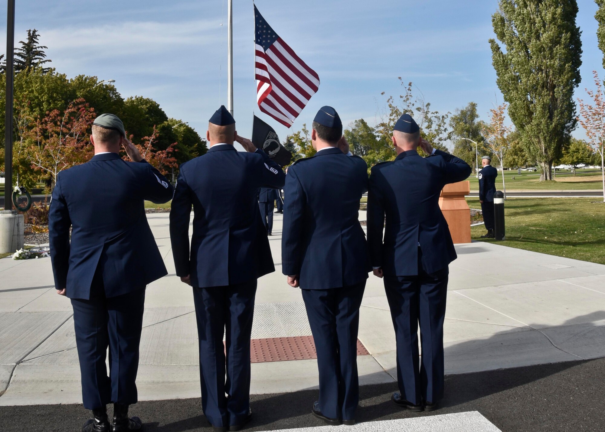 Fairchild leadership salute the American flag and the POW/MIA flag during the POW/MIA recognition day ceremony Sept. 16, 2016, at Fairchild Air Force Base, Wash. The ceremony was to honor American Prisoners of War and those Missing in Action.(U.S. Air Force photo/Airman 1st Class Taylor Shelton)