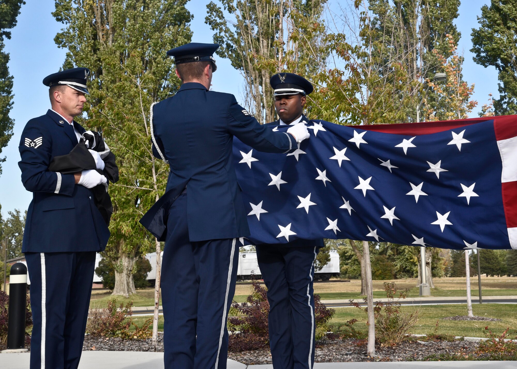 Members of the Base Honor Guard fold the American flag during the POW/MIA recognition day ceremony Sept. 16, 2016, at Fairchild Air Force Base, Wash. The ceremony serves two purposes: first it signals the official end of the duty day and it also serves as a tribute to the POW/MIA flag and the people for which it flies. (U.S. Air Force photo/Airman 1st Class Taylor Shelton)