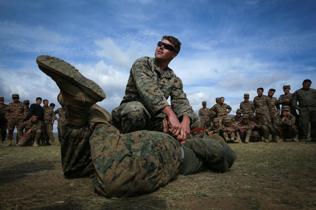 U.S. Marine Cpl. Samuel Masse demonstrates mechanical advantage control holds technique on Cpl. Adrian Davis during the Non-Lethal Executive Seminar (NOLES) 2016 at the Five Hills Training Area, Mongolia, Sept. 16, 2016. Both Masse and Davis are military police Marines with 3rd Law Enforcement Battalion, III Marine Expeditionary Force. Mongolian soldiers and police learned mechanical advantage control holds techniques as an additional non-lethal option when apprehending suspects. NOLES is a regularly scheduled field training exercise and leadership seminar hosted annually by various nations throughout Asia Pacific. 