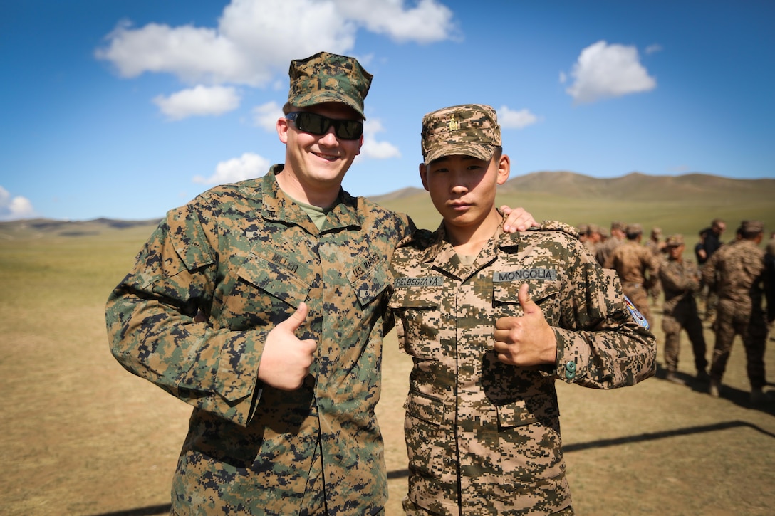 U.S. Marine Cpl. Philip Miller, a military police Marine from 3rd Law Enforcement Battalion, III Marine Expeditionary Force, and Mongolian Armed Forces Sgt. Elbergzaya, give thumbs up after the X-26E Taser exposure portion of the Non-Lethal Weapons Executive Seminar (NOLES) 2016 at the Five Hills Training Area, Mongolia, Sept. 13, 2016. Both U.S. Marines and Mongolian Armed Forces members received electrical shocks from the X-26E Taser. NOLES is a regularly scheduled field training exercise and leadership seminar hosted annually by various nations throughout Asia-Pacific. 