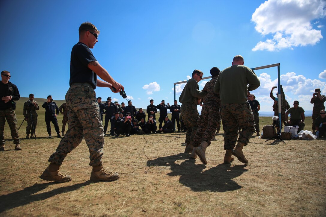 U.S. Marine Cpl. Samuel Masse, a military police Marine with 3rd Law Enforcement Battalion, III Marine Expeditionary Force, fires an X-26E Taser during the Taser exposure portion of the Non-Lethal Weapons Executive Seminar 2016, at the Five Hills Regional Peace Support Operations Training Center, Mongolia, Sept. 13, 2016. Both U.S. Marines and Mongolian Armed Forces members received electrical shocks from the X-26E Taser. NOLES is a regularly scheduled field training exercise and leadership seminar hosted annually by various nations throughout Asia-Pacific.