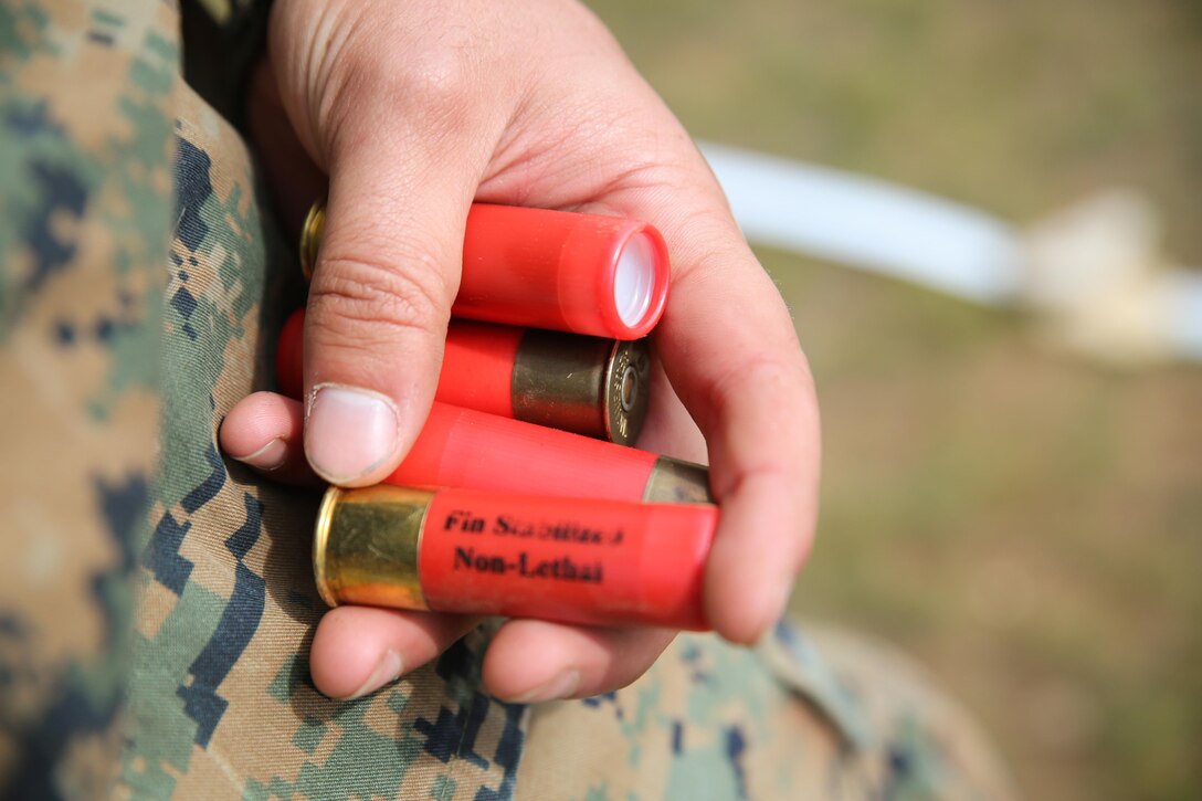 A U.S. Marine holds non-lethal rounds for a Mossberg 500A2 shotgun during Non-Lethal Executive Seminar (NOLES) 2016 at Five Hills Training Area, Mongolia, Sept. 15, 2016. Mongolian police and soldiers fired non-lethal munitions from the M203 grenade launcher, Mossberg 500A2 shotgun, and the M32 grenade launcher. NOLES is a regularly scheduled field training exercise and leadership seminar hosted annually by various nations throughout Asia Pacific. 