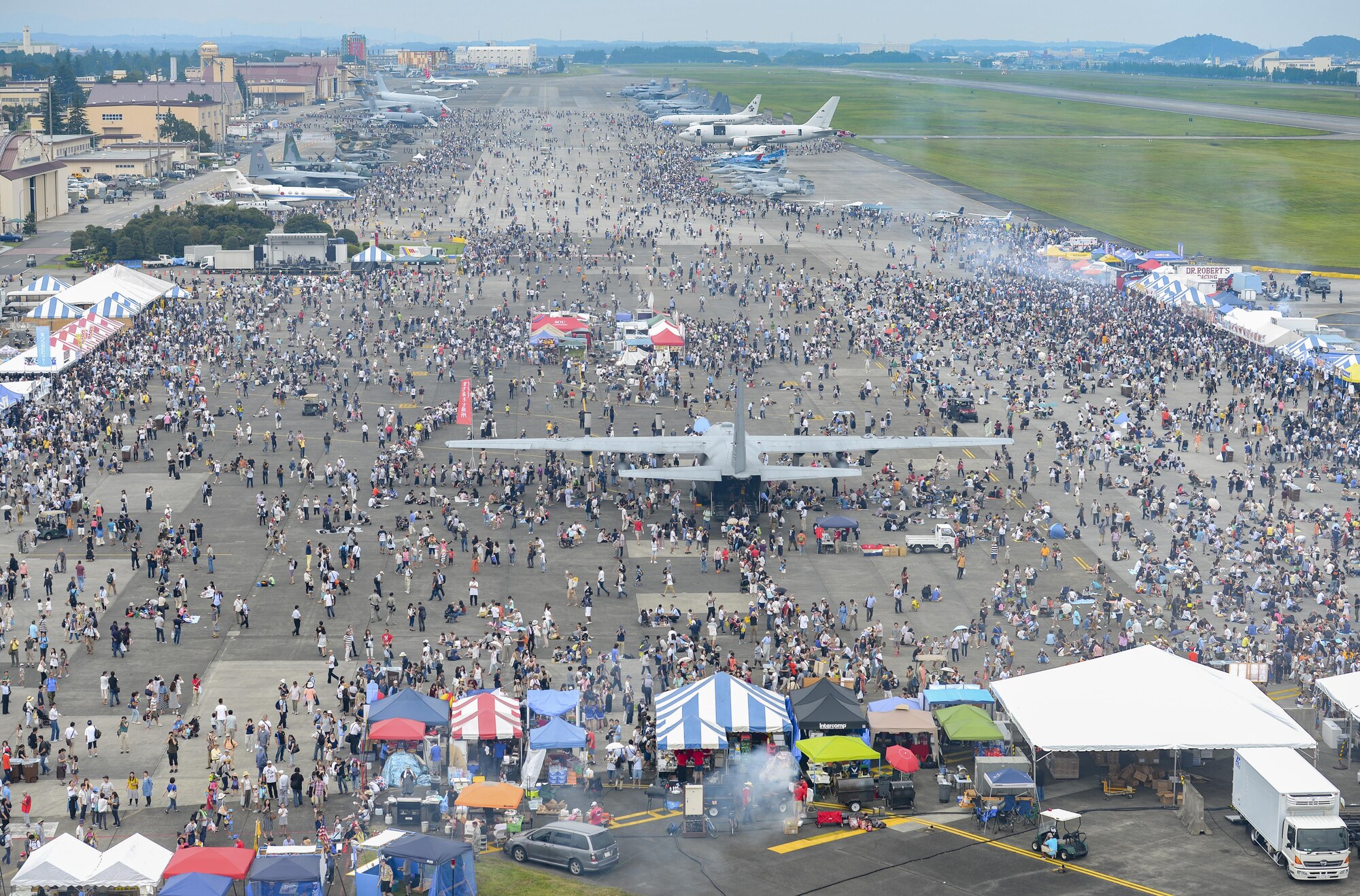 The 36th Airlift Squadron demonstrates a low-cost, low-altitude cargo drop on the air field during the 2016 Japanese-American Friendship Festival at Yokota Air Base, Japan, Sept. 17, 2016. The festival hosted food vendors, static aircraft displays, live entertainment and military and government demonstrations.  (U.S. Air Force photo by Airman 1st Class Elizabeth Baker/Released)