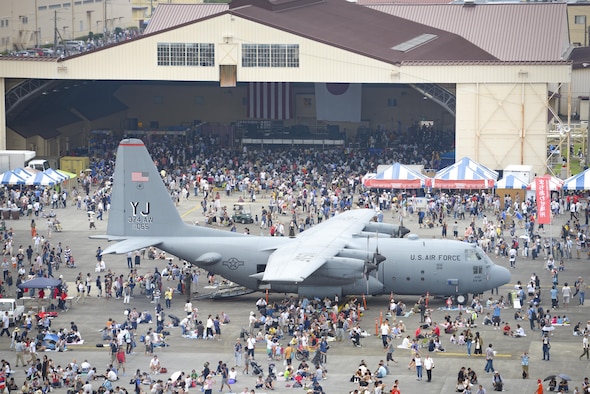 The 36th Airlift Squadron demonstrates a low-cost, low-altitude cargo drop on the air field during the 2016 Japanese-American Friendship Festival at Yokota Air Base, Japan, Sept. 17, 2016. The festival hosted food vendors, static aircraft displays, live entertainment and military and government demonstrations.  (U.S. Air Force photo by Airman 1st Class Elizabeth Baker/Released)
