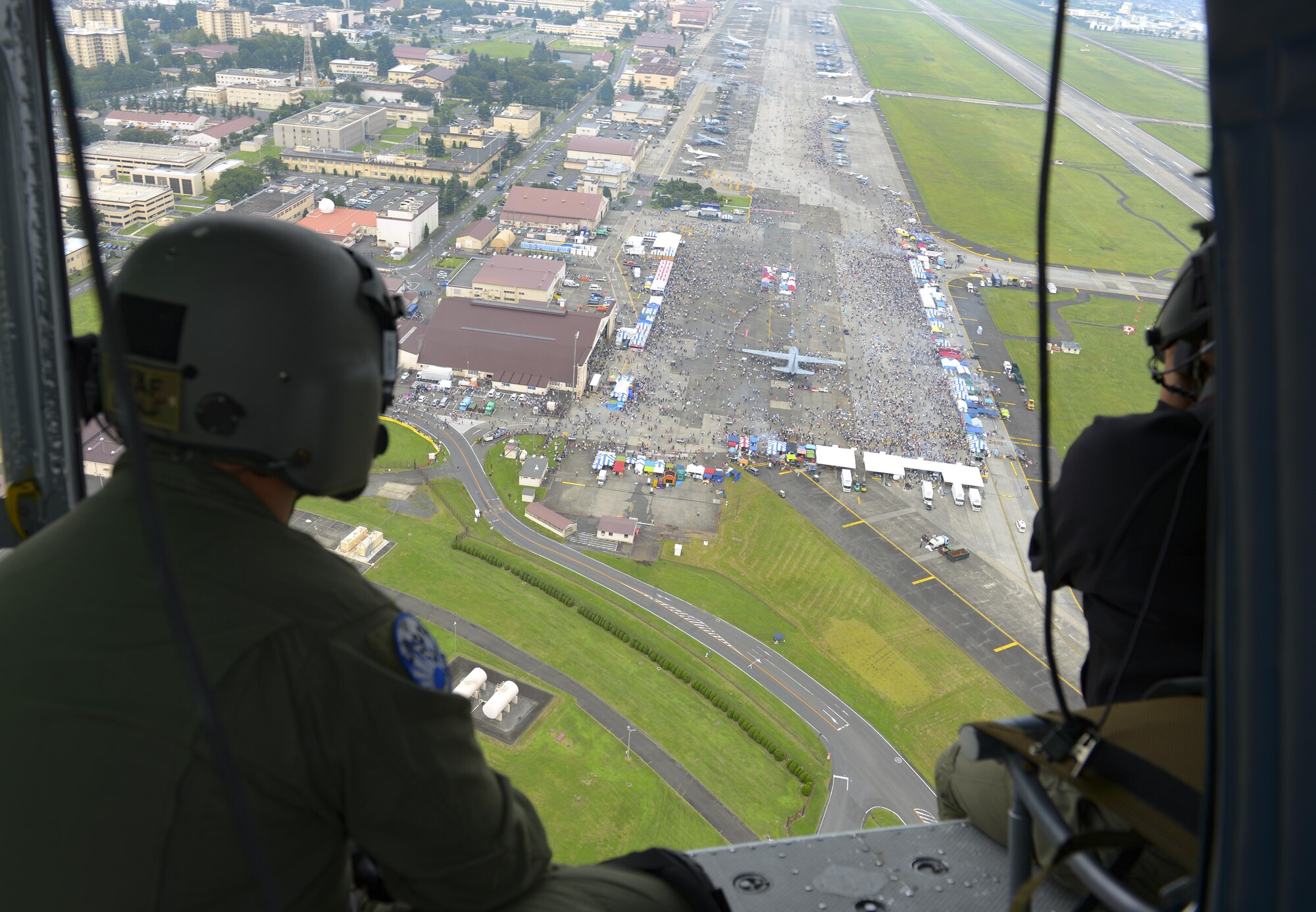 The 36th Airlift Squadron demonstrates a low-cost, low-altitude cargo drop on the air field during the 2016 Japanese-American Friendship Festival at Yokota Air Base, Japan, Sept. 17, 2016. The festival hosted food vendors, static aircraft displays, live entertainment and military and government demonstrations.  (U.S. Air Force photo by Airman 1st Class Elizabeth Baker/Released)