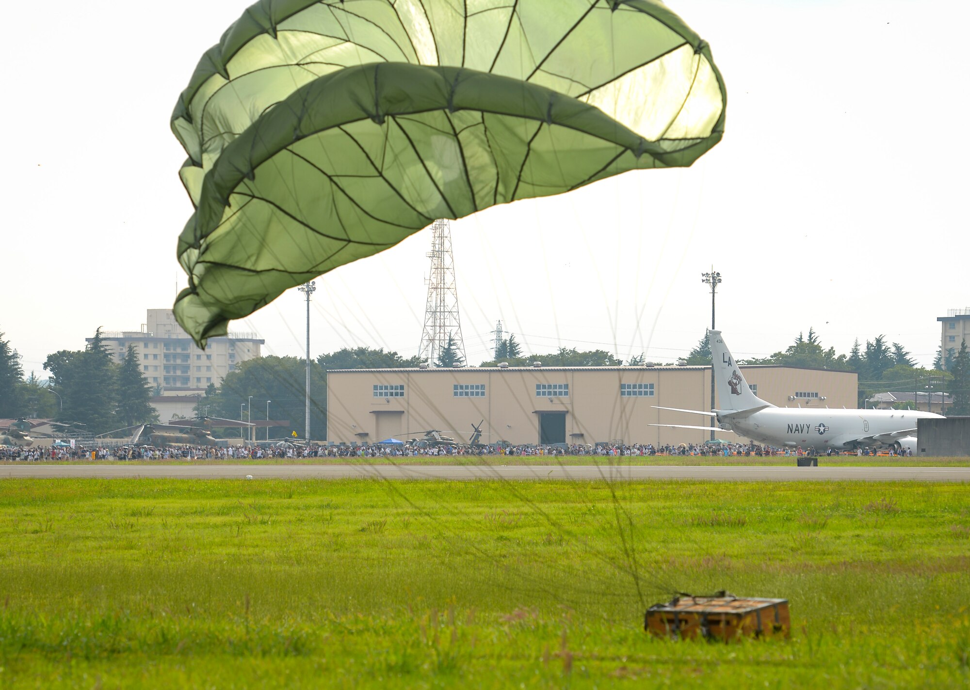 The 36th Airlift Squadron demonstrates a low-cost, low-altitude cargo drop on the air field during the 2016 Japanese-American Friendship Festival at Yokota Air Base, Japan, Sept. 17, 2016. The festival hosted food vendors, static aircraft displays, live entertainment and military and government demonstrations.  (U.S. Air Force photo by Airman 1st Class Elizabeth Baker/Released)