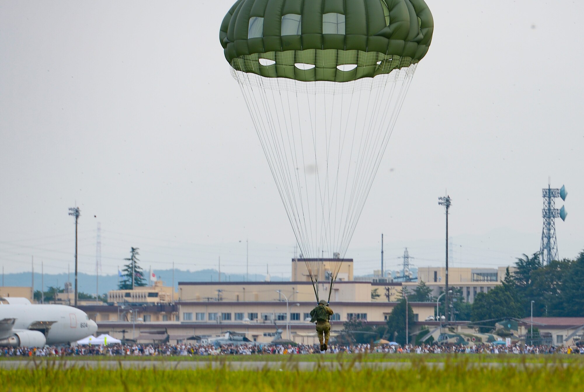 The 36th Airlift Squadron demonstrates a low-cost, low-altitude cargo drop on the air field during the 2016 Japanese-American Friendship Festival at Yokota Air Base, Japan, Sept. 17, 2016. The festival hosted food vendors, static aircraft displays, live entertainment and military and government demonstrations.  (U.S. Air Force photo by Airman 1st Class Elizabeth Baker/Released)