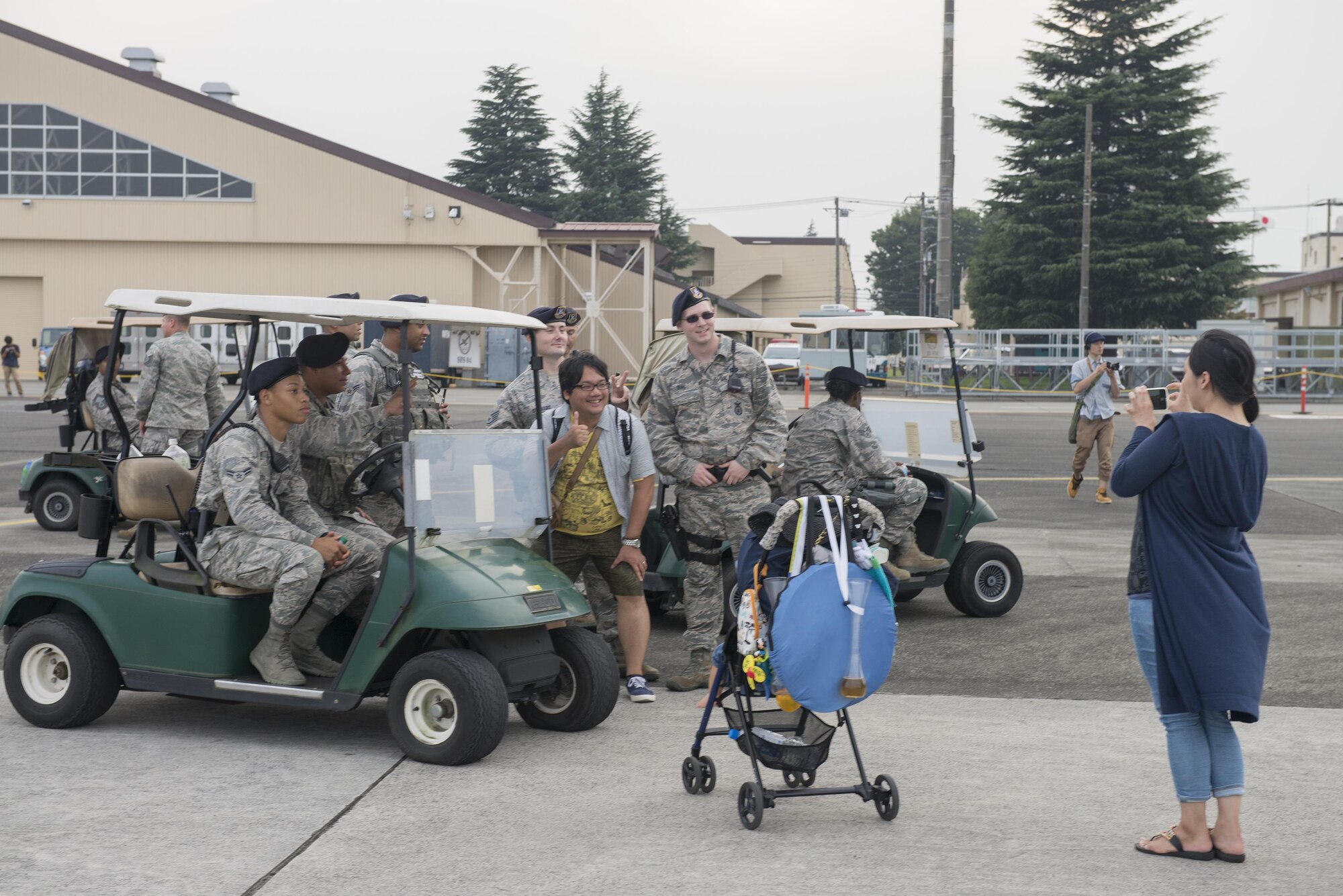A Japanese man poses for a photo with members of the 374th Security Forces Squadron during the 2016 Friendship Festival at Yokota Air Base, Japan, Sept. 17, 2016. The festival was an opportunity for visitors to experience American culture, while strengthening the bonds between Yokota and the local communities. (U.S. Air Force photo by Senior Airman David C. Danford/Released)