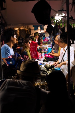 Friendship Festival attendees look at merchandise from one of many venders at the Friendship Festival on 17 Sept. 2016 at Yokota Air Base, Japan. The festival had many booths for food and gifts for attendees. (U.S. Air Force photo by Airman 1st Class Donald Hudson/Released)