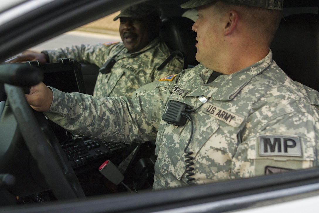 Spc. Bradley A. Skowronski, a U.S. Army Reserve military police Soldier assigned to the 102nd MP Company out of Sheboygan, Wisc., and Spc. Valery P. Nzams a U.S. Army Reserve military police Soldier assigned to the 443rd MP Company out of Bronx, N.Y., talk about their duties during a patrol on Fort Meade, Md., Sept. 16, 2016.  Skowronski and Nzams are part of a group of Soldiers participating in the ongoing partnership between the 200th Military Police Command and the Military District of Washington. (U.S. Army Reserve photo by Spc. Stephanie Ramirez) 