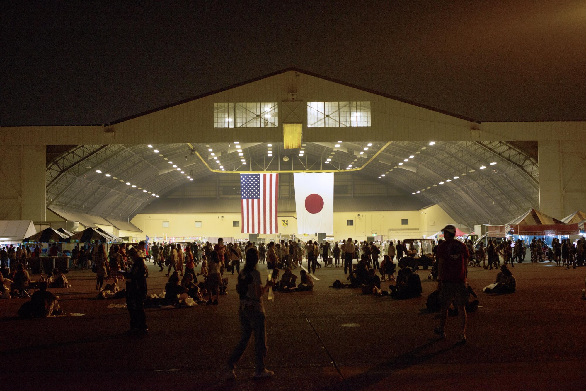 Visitors gather in a hanger to hear the Air Force Band play at the Friendship Festival on 17 Sept. 2016 at Yokota Air Base, Japan. The festival had many bands playing throughout the day on two different stages. (U.S. Air Force photo by Airman 1st Class Donald Hudson/Released)