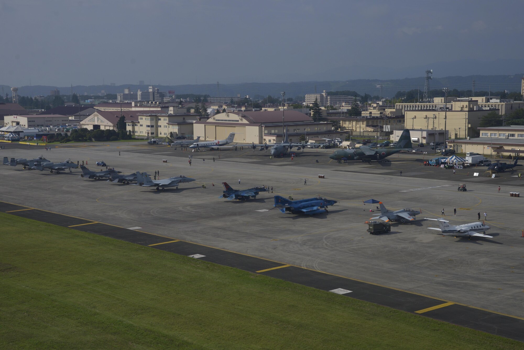 Aircraft from the United States and Japan military sit on the flightlight before the gates open for the Friendship Festival at Yokota Air Base, Japan, Sept. 17, 2016. Approximately 185,000 people visited the festival in 2015. (U.S. Air Force photo by Senior Airman David Owsianka/Released)